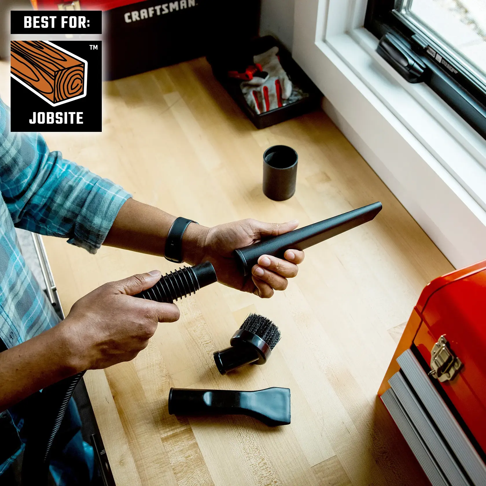 Person attaching the CRAFTSMAN 1-1/4 inch Crevice Tool Attachment to vac hose at workbench