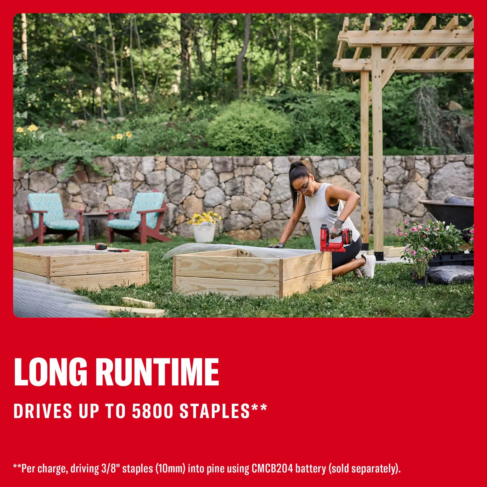 Photo of a person using a Craftsman cordless stapler CMCN410B outdoors to build a wooden garden bed next to flowers and tools.