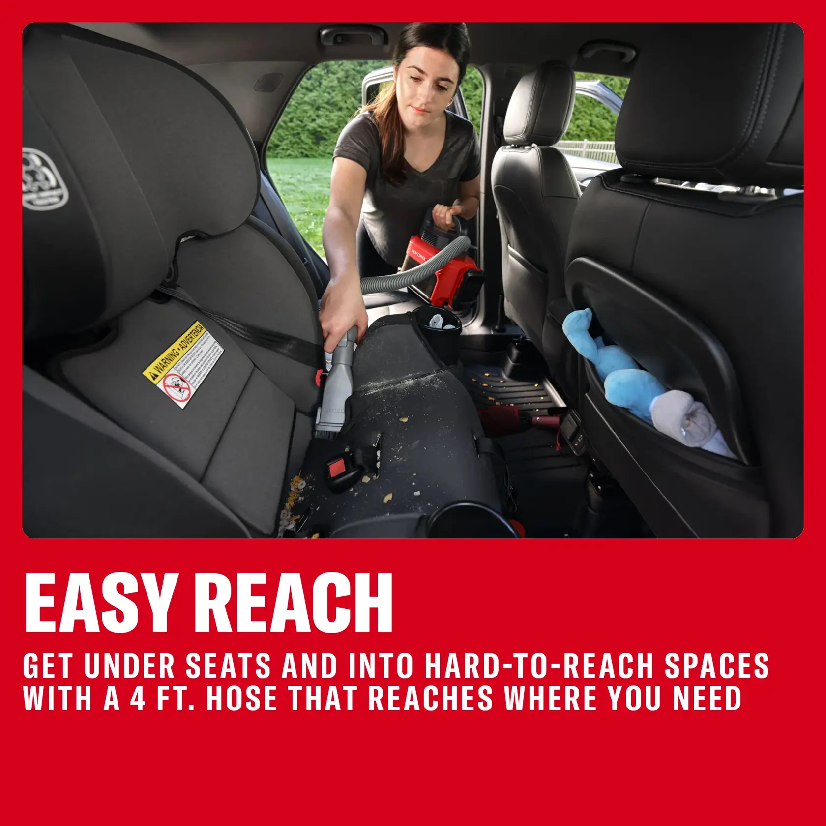 Person uses a Craftsman handheld vacuum with hose to clean a car's backseat area, reaching tight spaces easily.