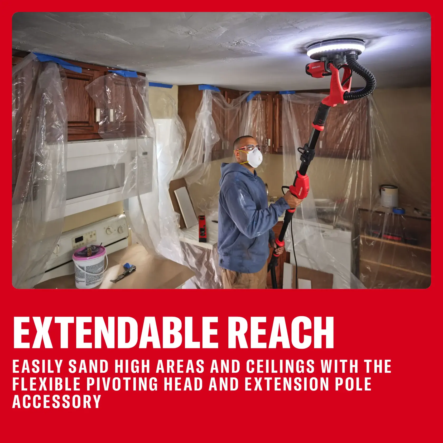 Person sands ceiling with a red extendable tool in a covered kitchen, highlighting flexible head and pole accessory.