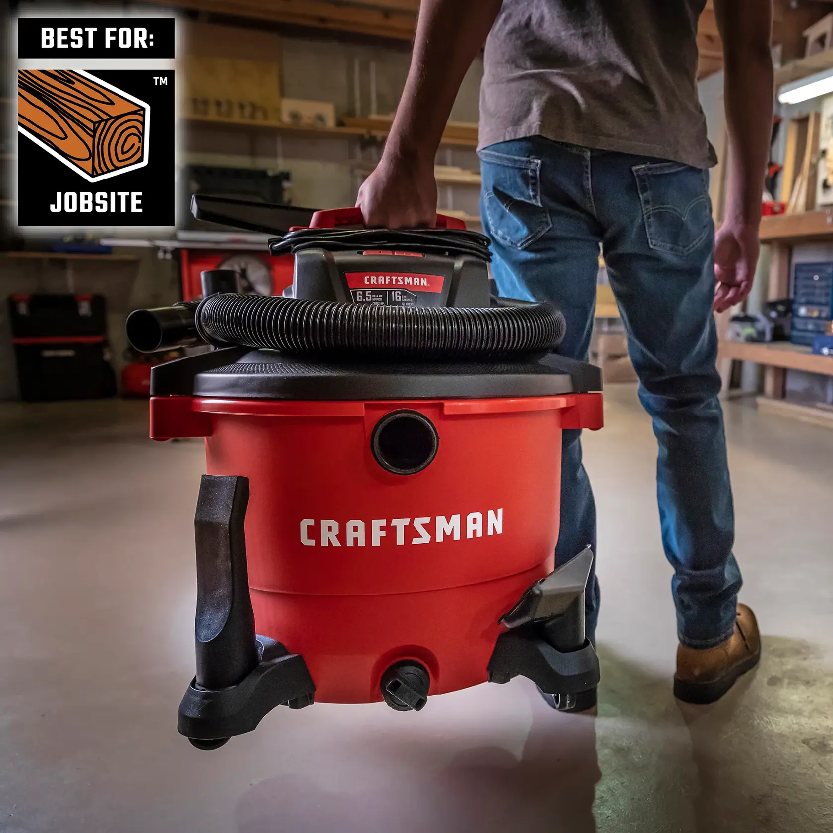 Man carrying the CRAFTSMAN Wet/Dry Vac on a jobsite by convenient handle 