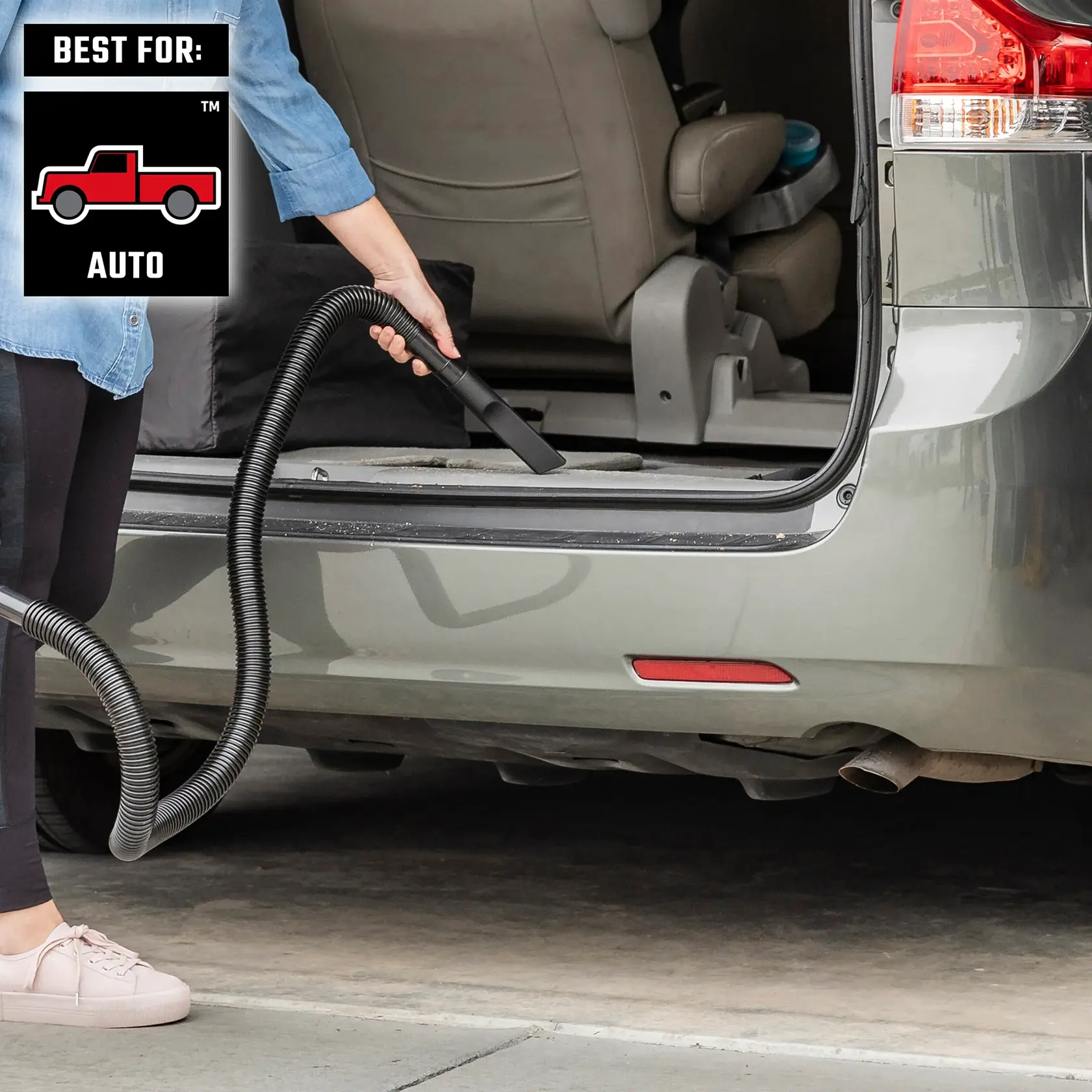 Person cleaning the back storage area of mini van with a wet/dry vac best for auto 