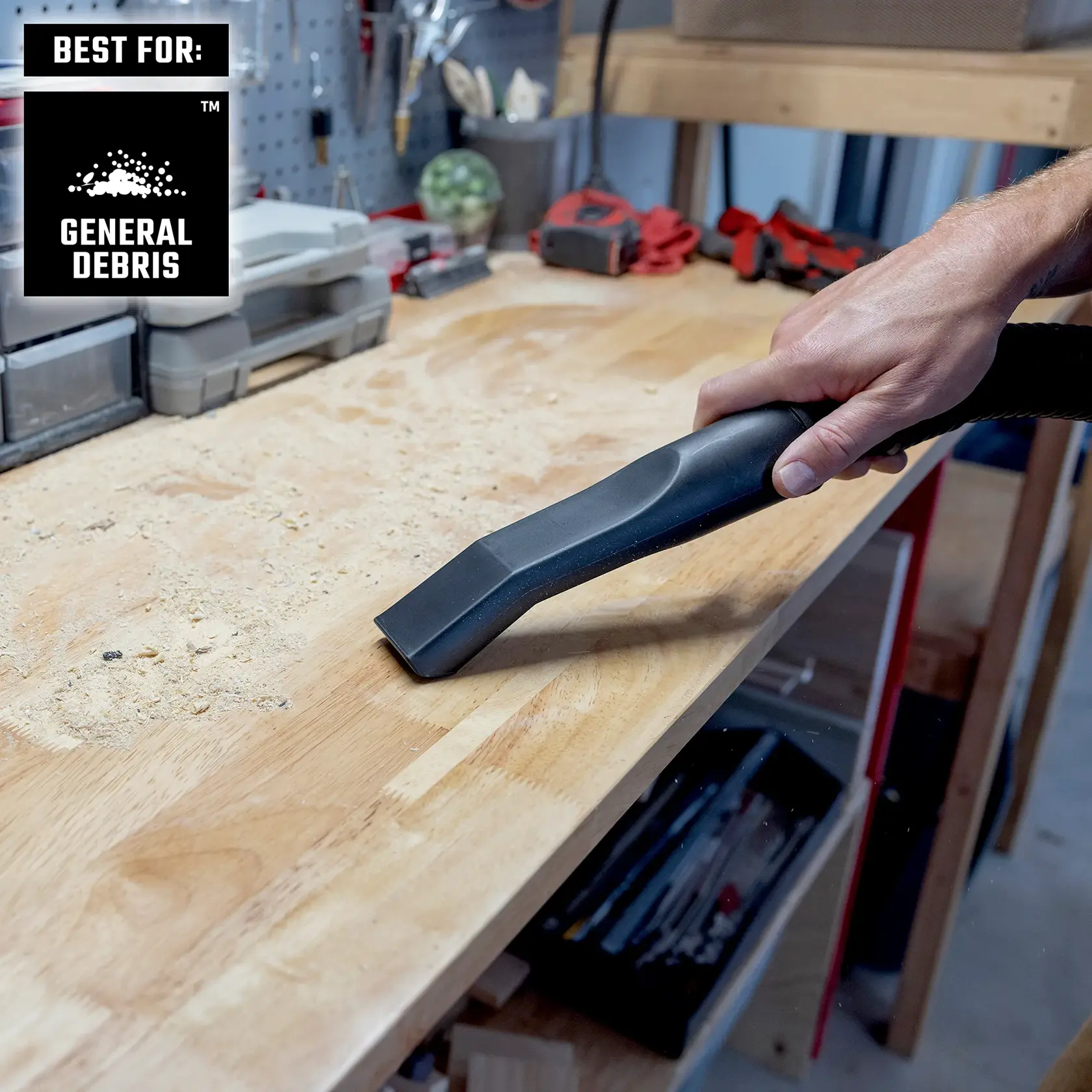 Hand vacuuming sawdust and general debris from workbench in workshop with Wet/Dry Vac
