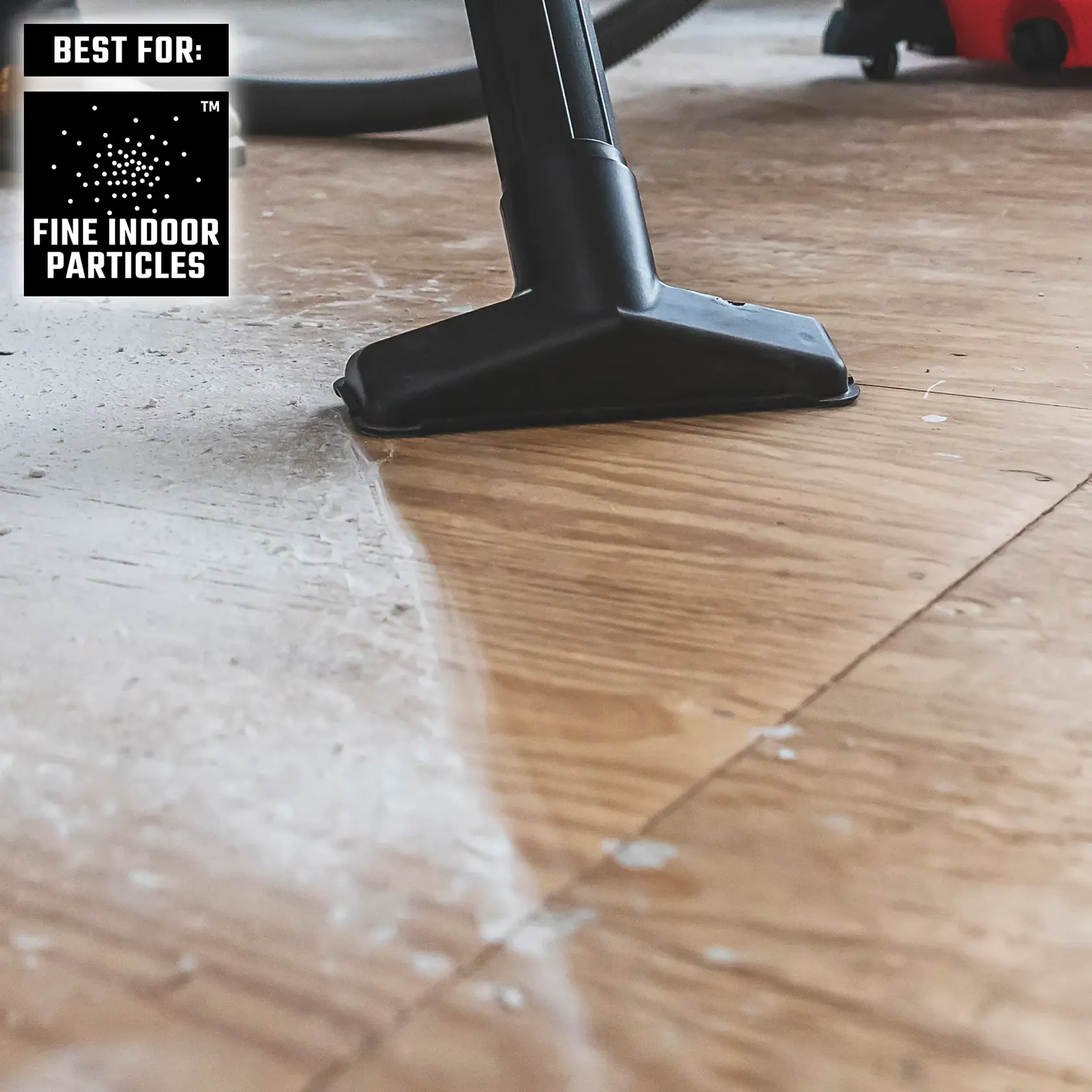 DIYer vacuuming fine indoor particles from wood floor with CRAFTSMAN Wet/Dry Vac and utility nozzle