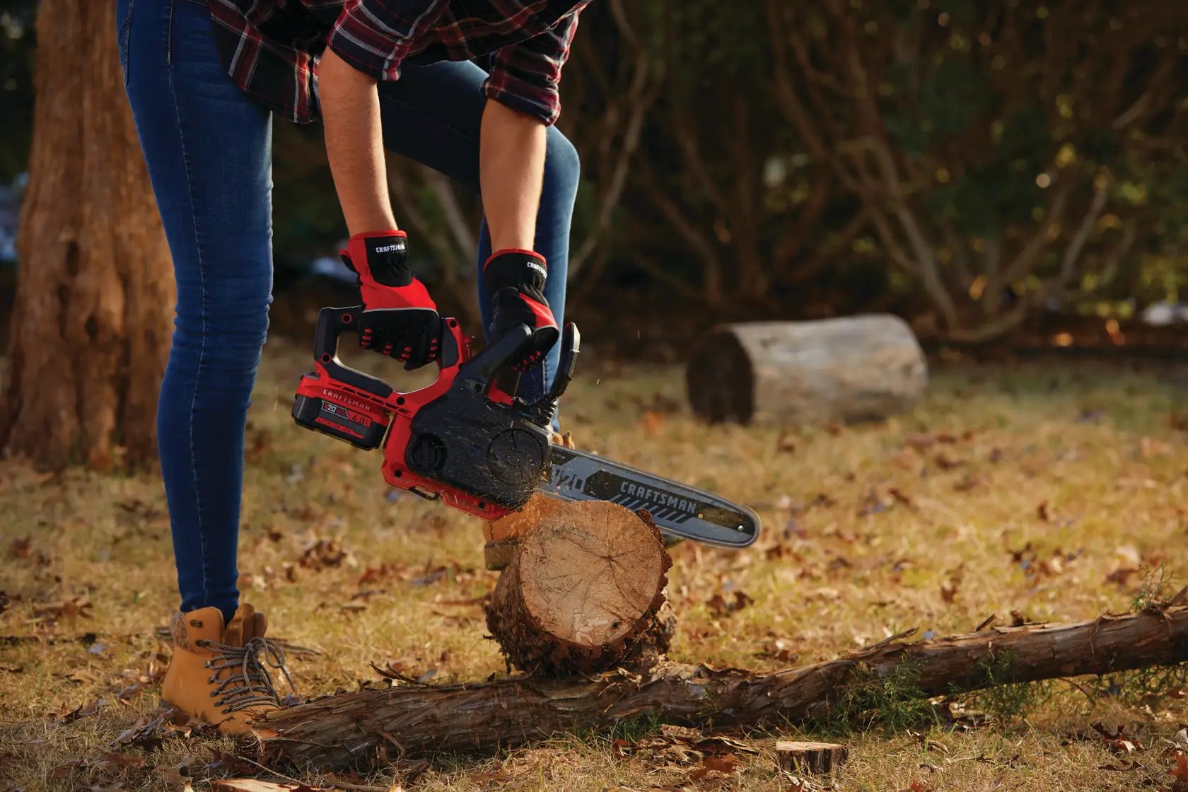 12 inch cordless compact chainsaw kit 4 amp hour being used for cutting log of wood.