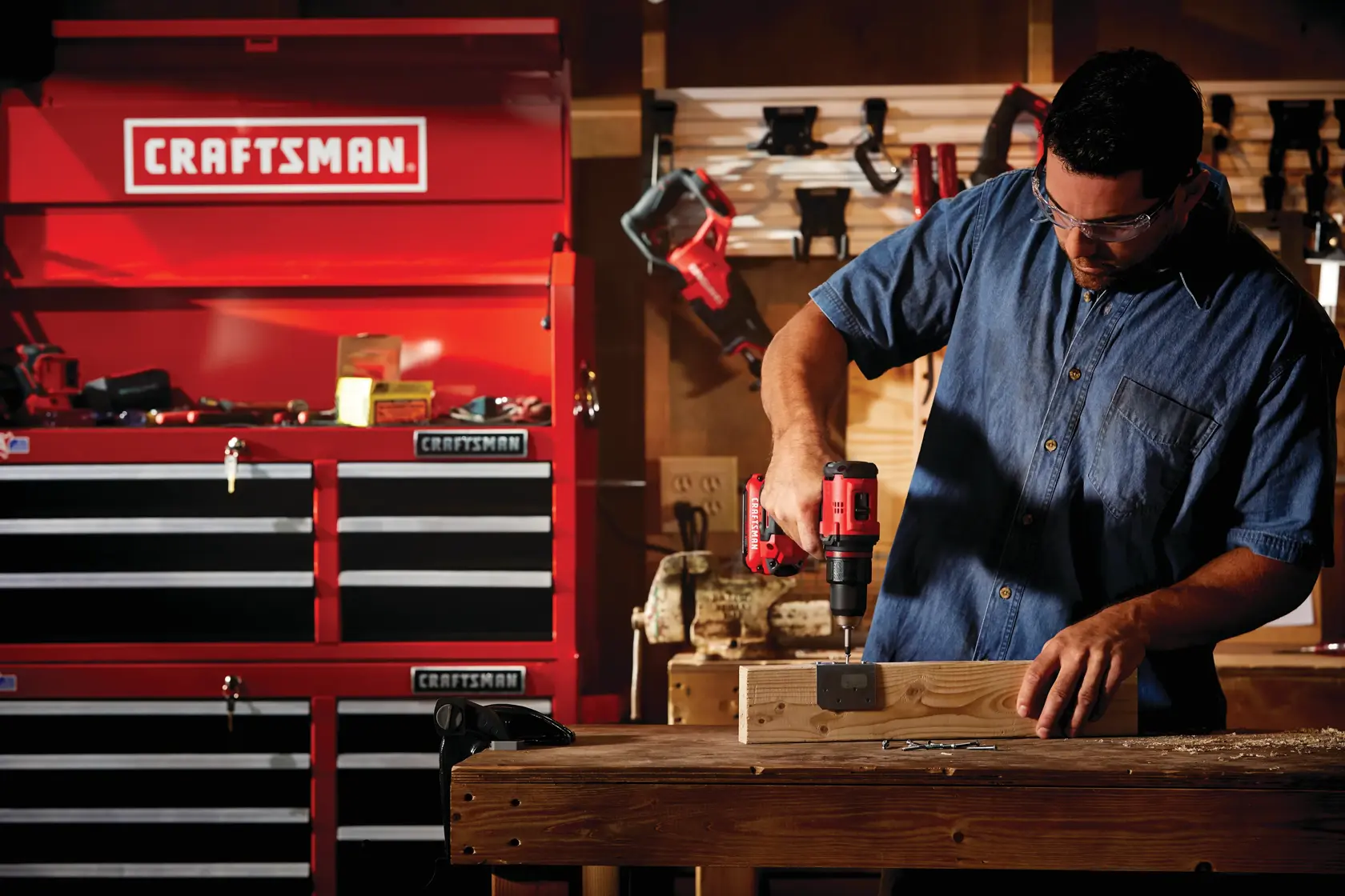 Cordless brushless half inch drill and driver kit 1 battery being used for fixing hinge on wood block.