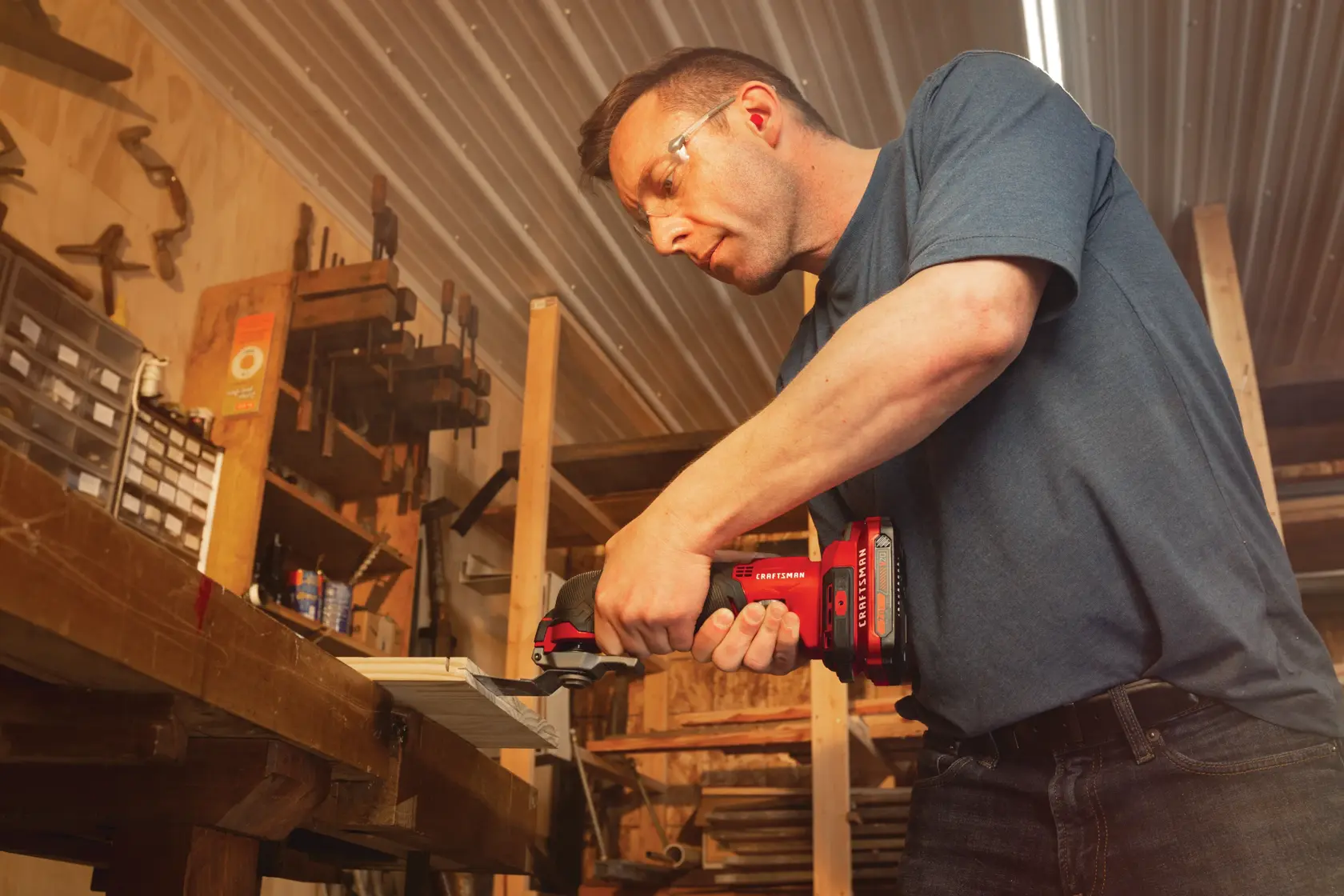 Cordless oscillating tool kit being used on wood.