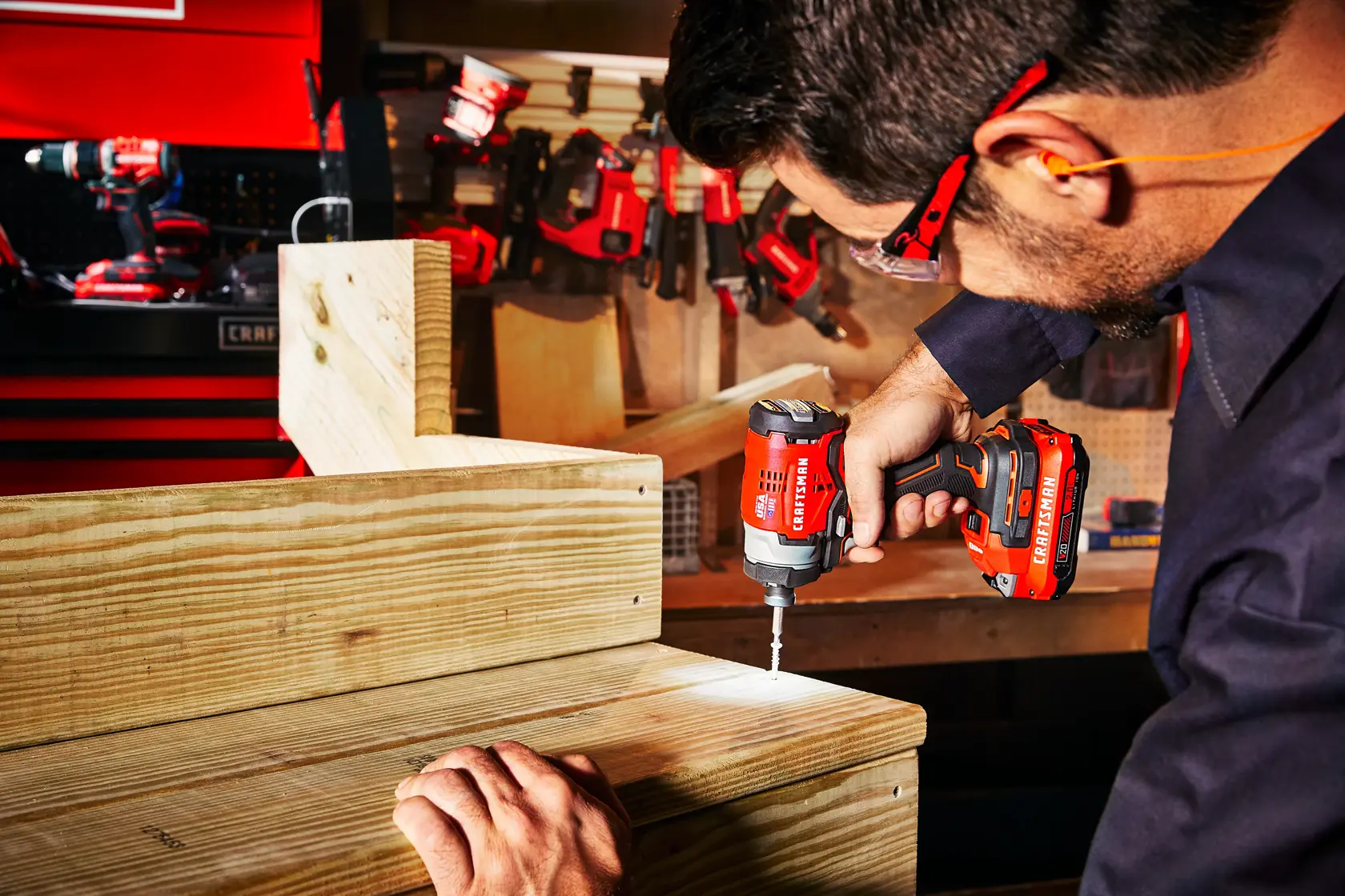 Brushless cordless impact driver 2 batteries being used to drive screws.