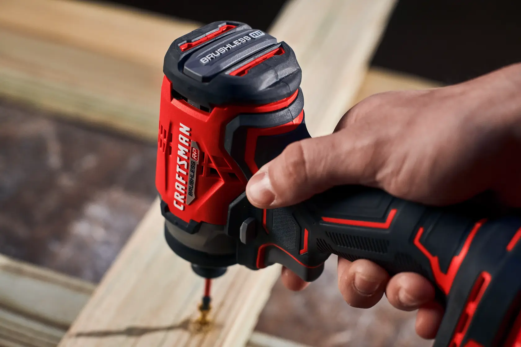 Man in dark shirt drills into wood with CRAFTSMAN V20 drill.