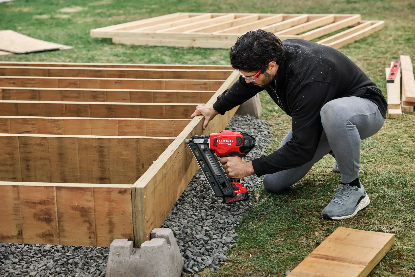 Man building deck with CRAFTSMAN BRUSHLESS RP™ V20* 30° Paper Collated Framing Nailer 