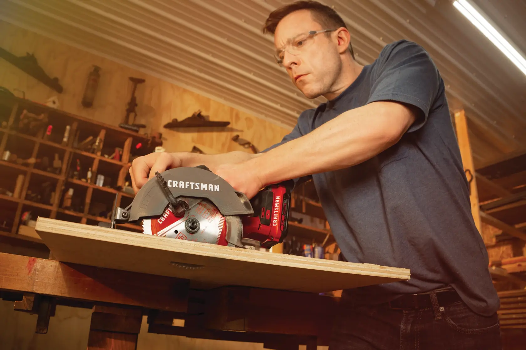 20 volt cordless 6 1 half inch circular saw kit being used by a person to cut wooden plank.