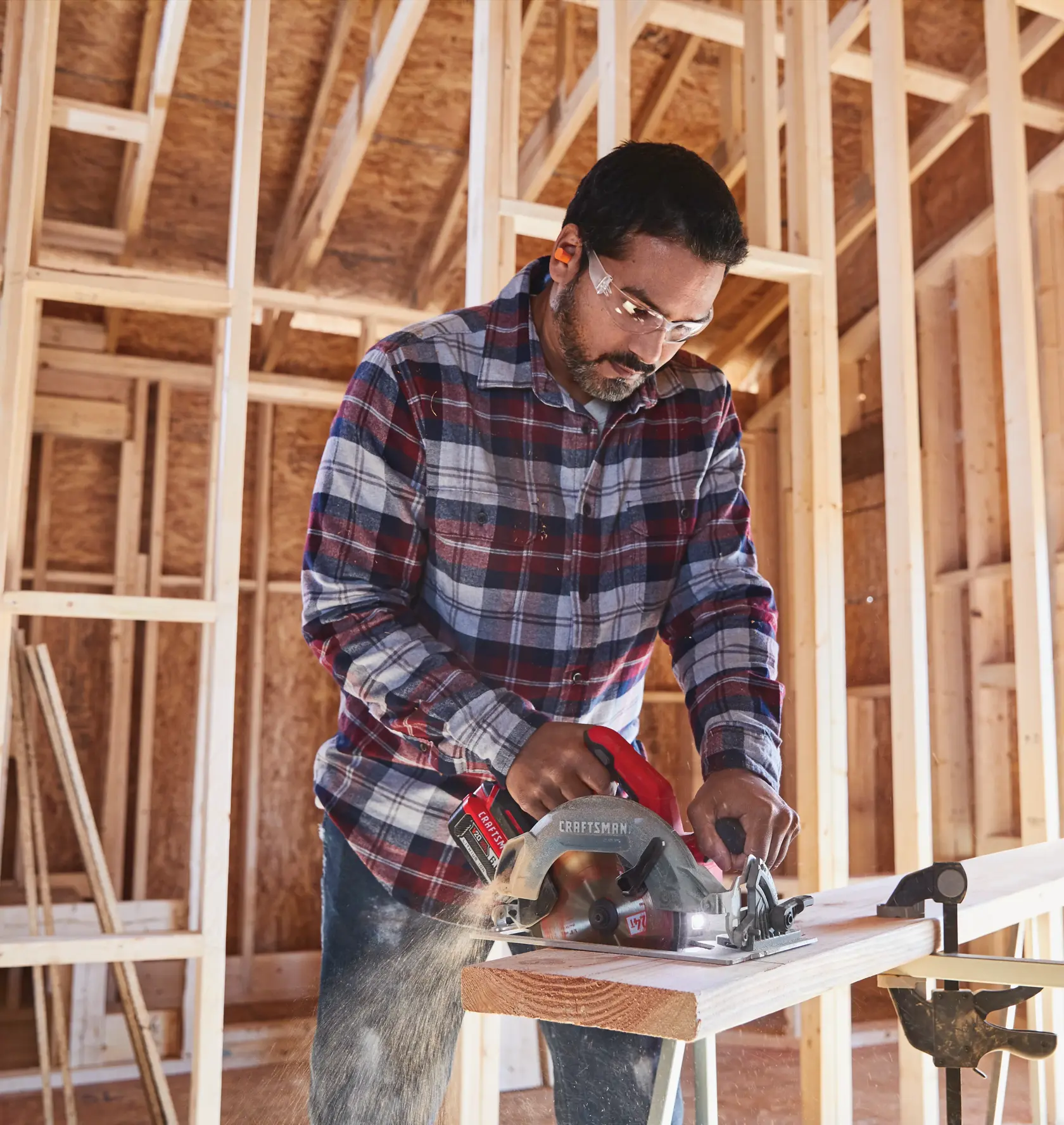 20 volt 7 1 quarter inch brushless cordless circular saw being used by a person to cut wooden plank.