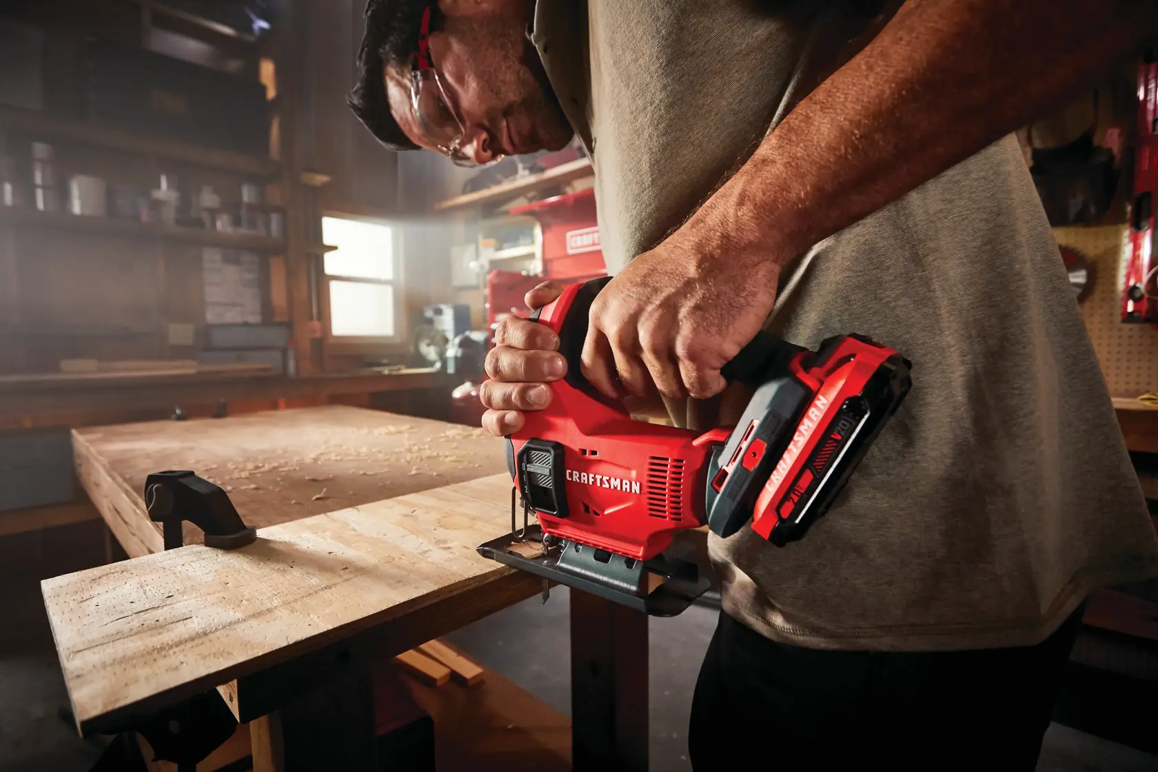 20 volt cordless jig saw kit being used by a person to cut a wood.
