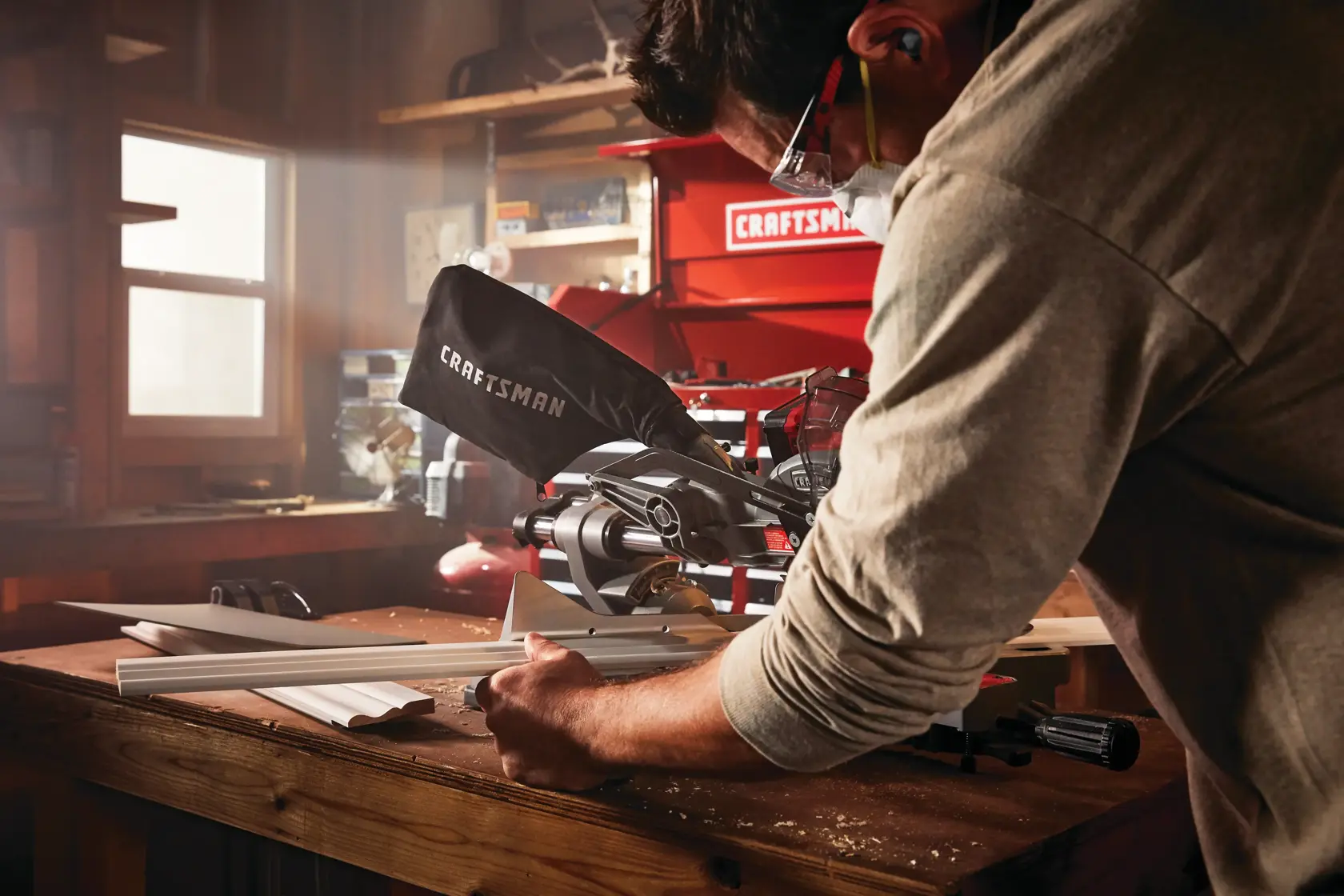 20 volt cordless 7 1 quarter inch sliding miter saw kit being used by a person at a workshop.