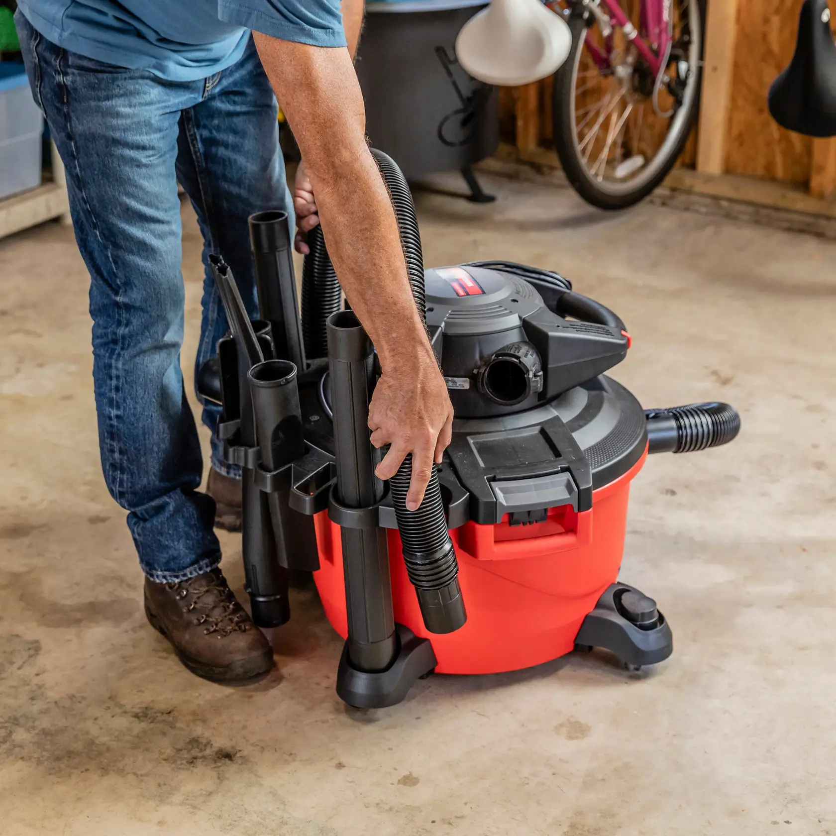 Person latching hose to caddy for the CRAFTSMAN 12 Gallon Wet Dry Shop Vacuum with blower