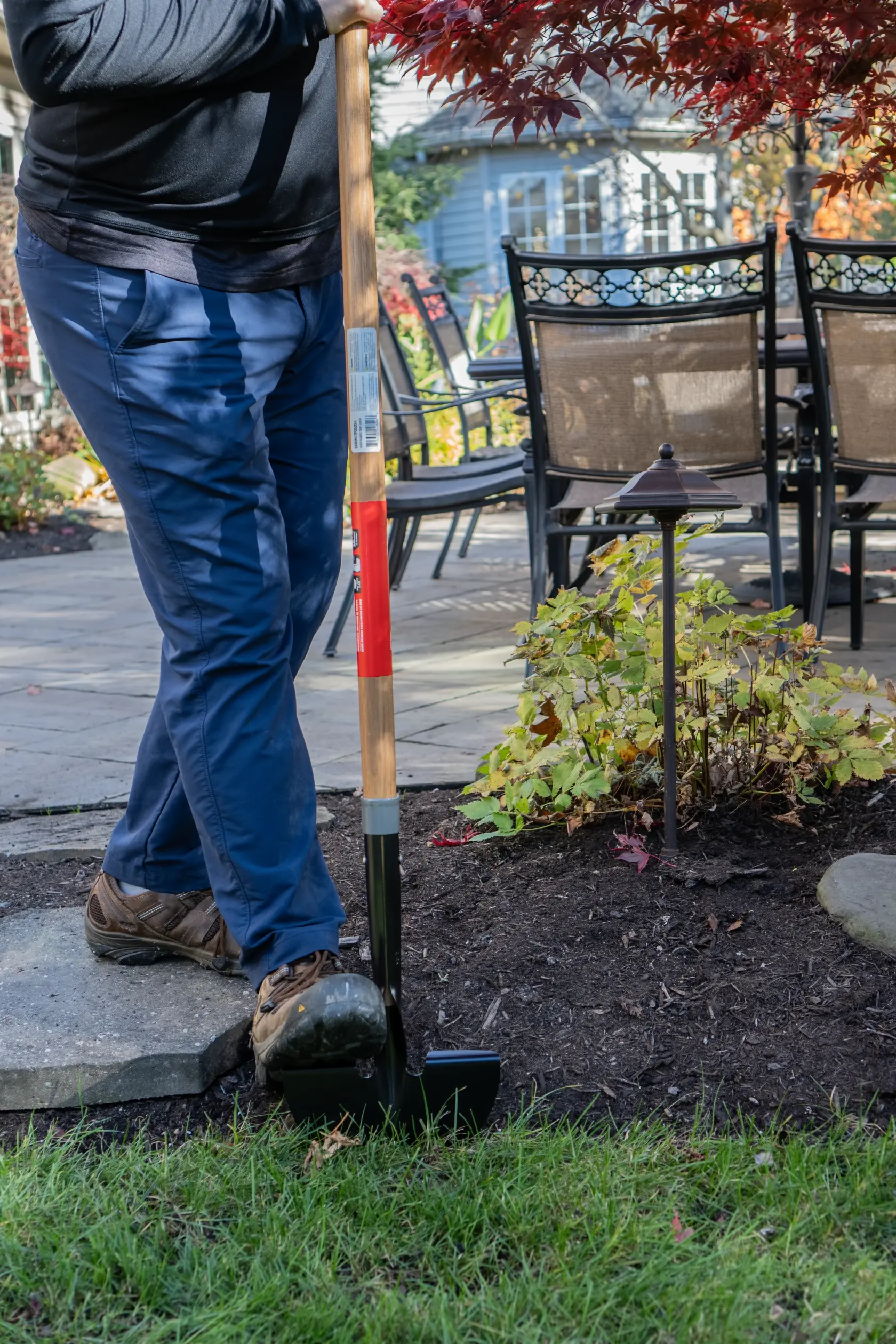 Long Handle Half Moon Shaped Steel Landscape Bed Edger with wood handle and cushion grip, in action 