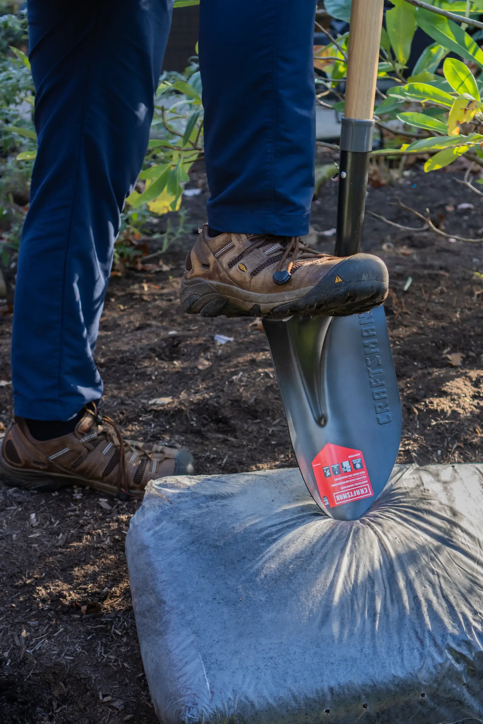Long Handle Cleated Step Digging Shovel with wood handle and cushion grip, in action 
