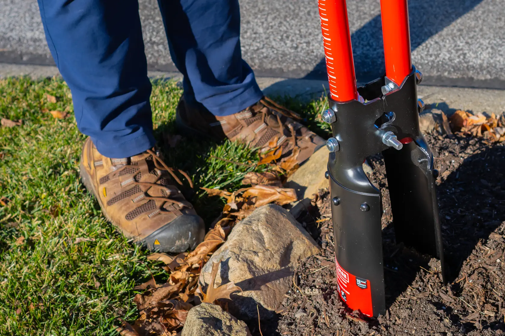 Two Handle Post Hold Digger with fiberglass handles and cushioin grips, in action digging