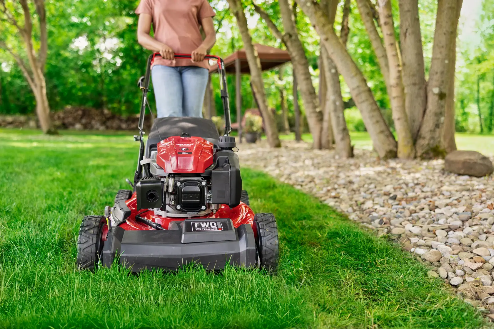 Woman cutting grass with CRAFTSMAN M220C Gas Walk-behind Mower