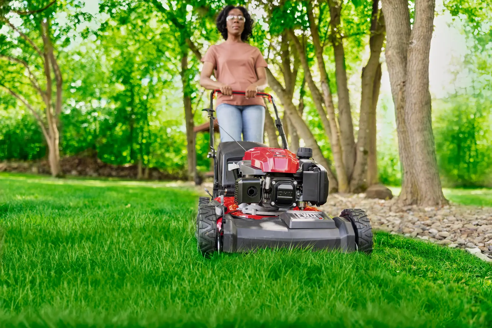 Woman cutting grass with CRAFTSMAN M220C Gas Walk-behind Mower
