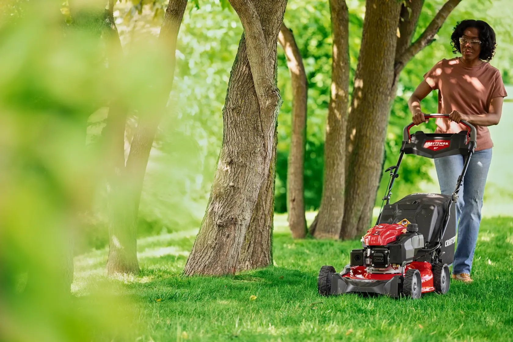 Woman cutting grass with CRAFTSMAN M320C Gas Walk-behind Mower