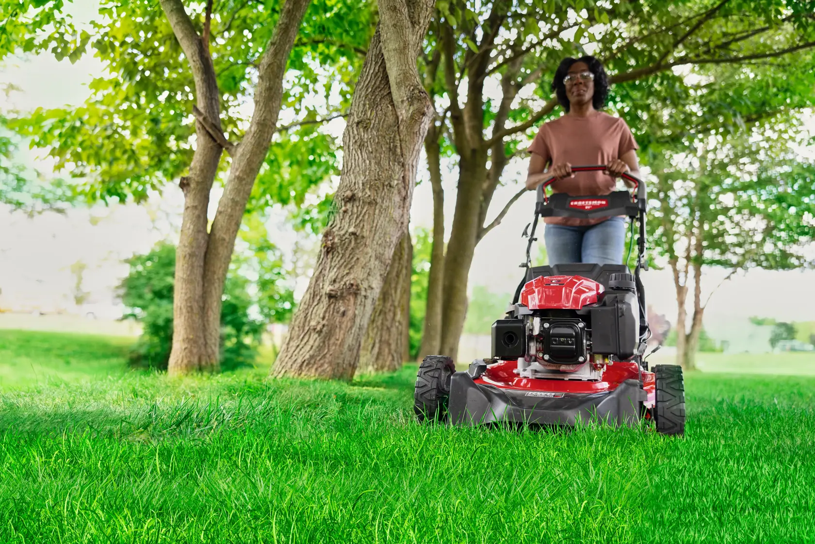 Woman cutting grass with CRAFTSMAN M320C Gas Walk-behind Mower