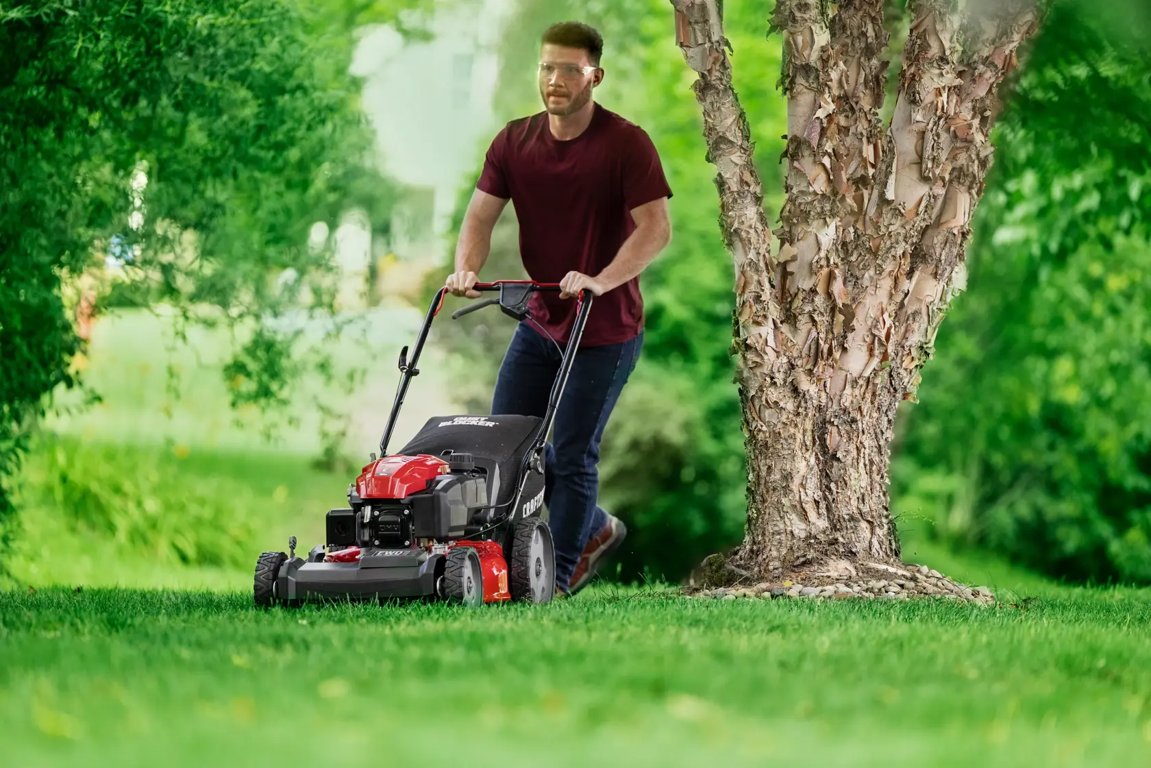 Man cutting grass with CRAFTSMAN M230C Gas Walk-behind Mower
