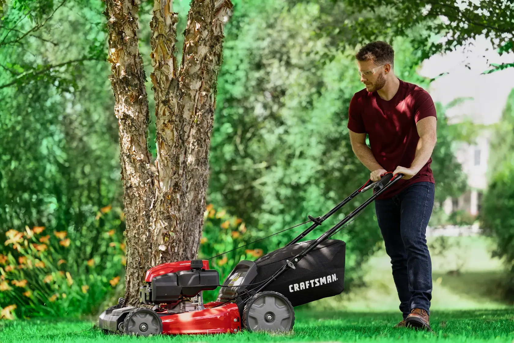 Man cutting grass with CRAFTSMAN M230C Gas Walk-behind Mower