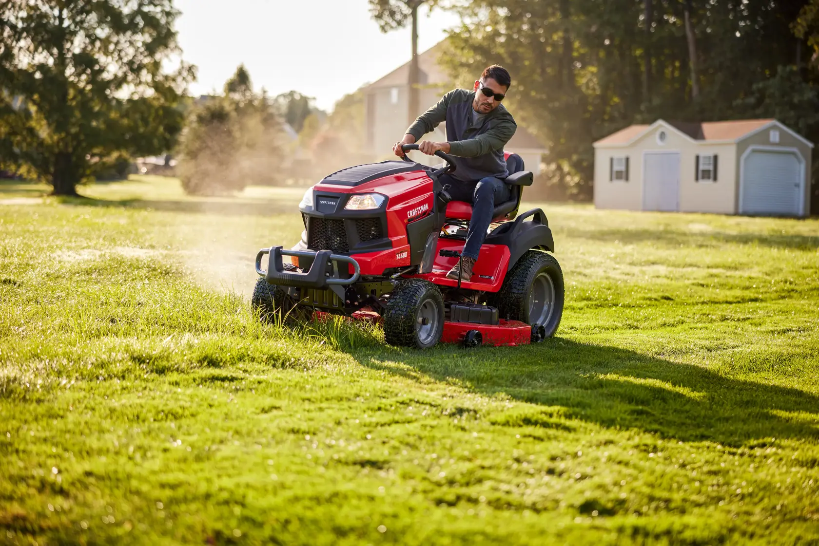 Side angle view of male riding T4400 Tractor about to turn