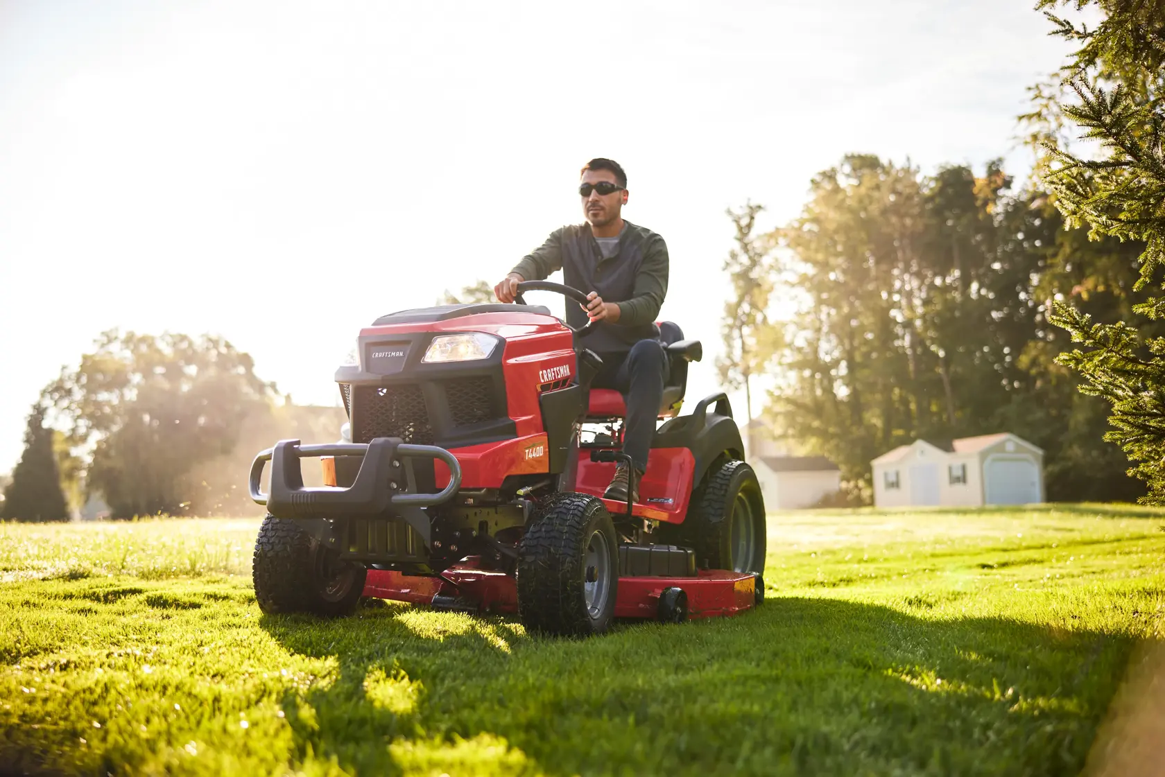 Side angle view of male riding T4400 Tractor 