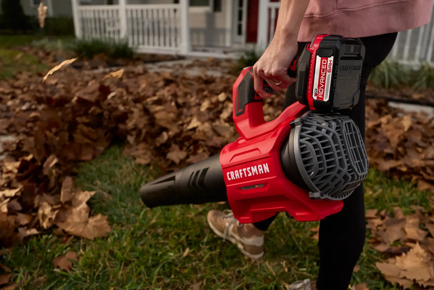 Person uses the Craftsman 20V leaf blower to clear a patch of grass