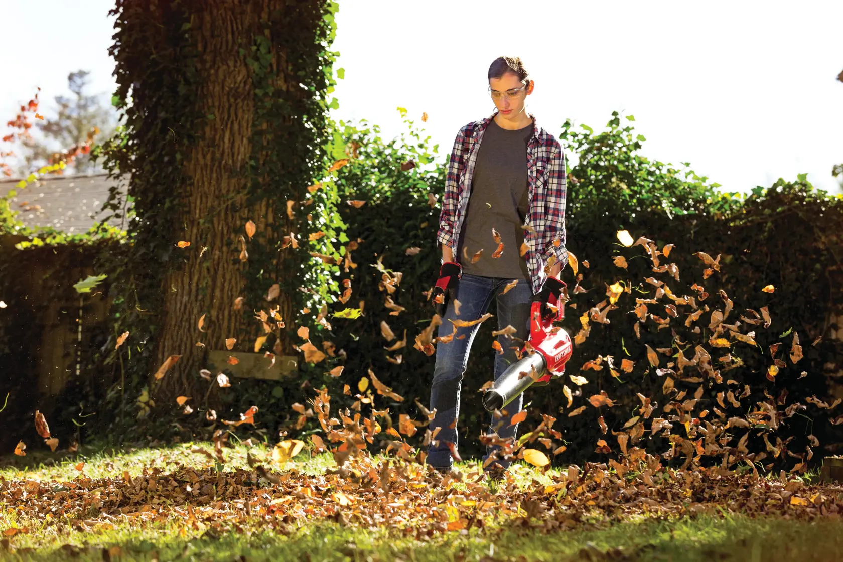Photo of Craftsman leaf blower SKU CMCBL720M1 in use outdoors, blowing leaves on grassy yard.