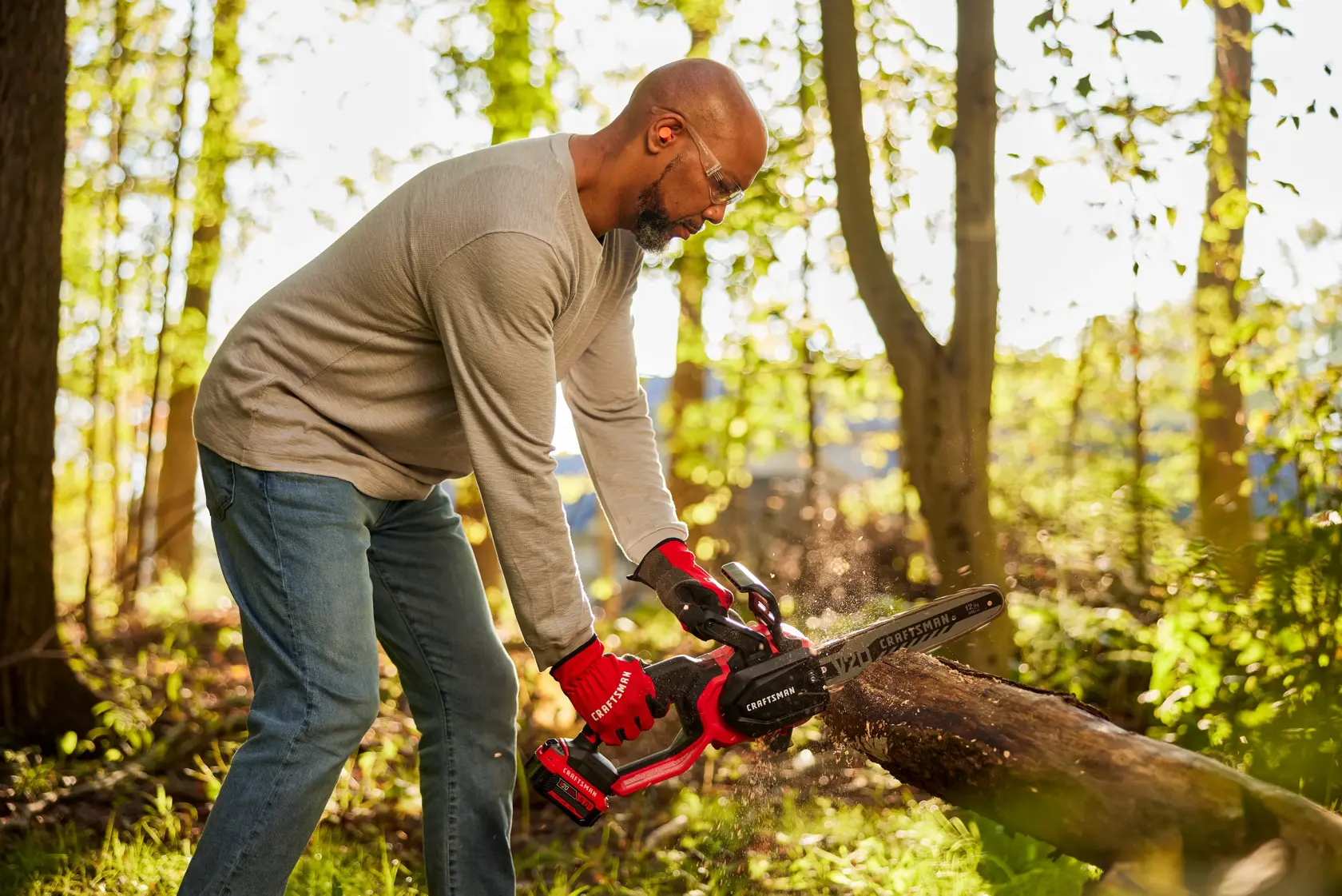 Zoom in of male cutting with V20 Chainsaw 
