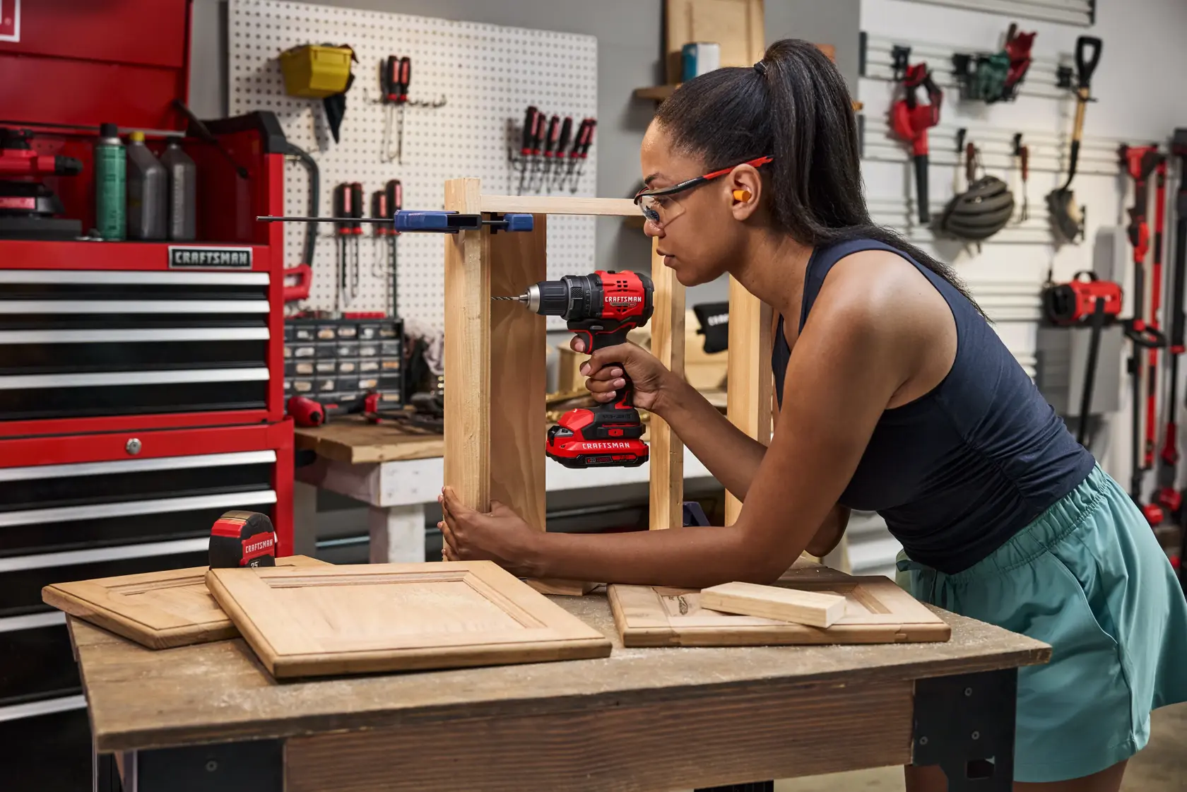 Wide angle of woman drilling into drawer furniture with the CRAFTSMAN® V20* BRUSHLESS RP™ Compact Drill/Driver. Additional Items Pictured Not Included
