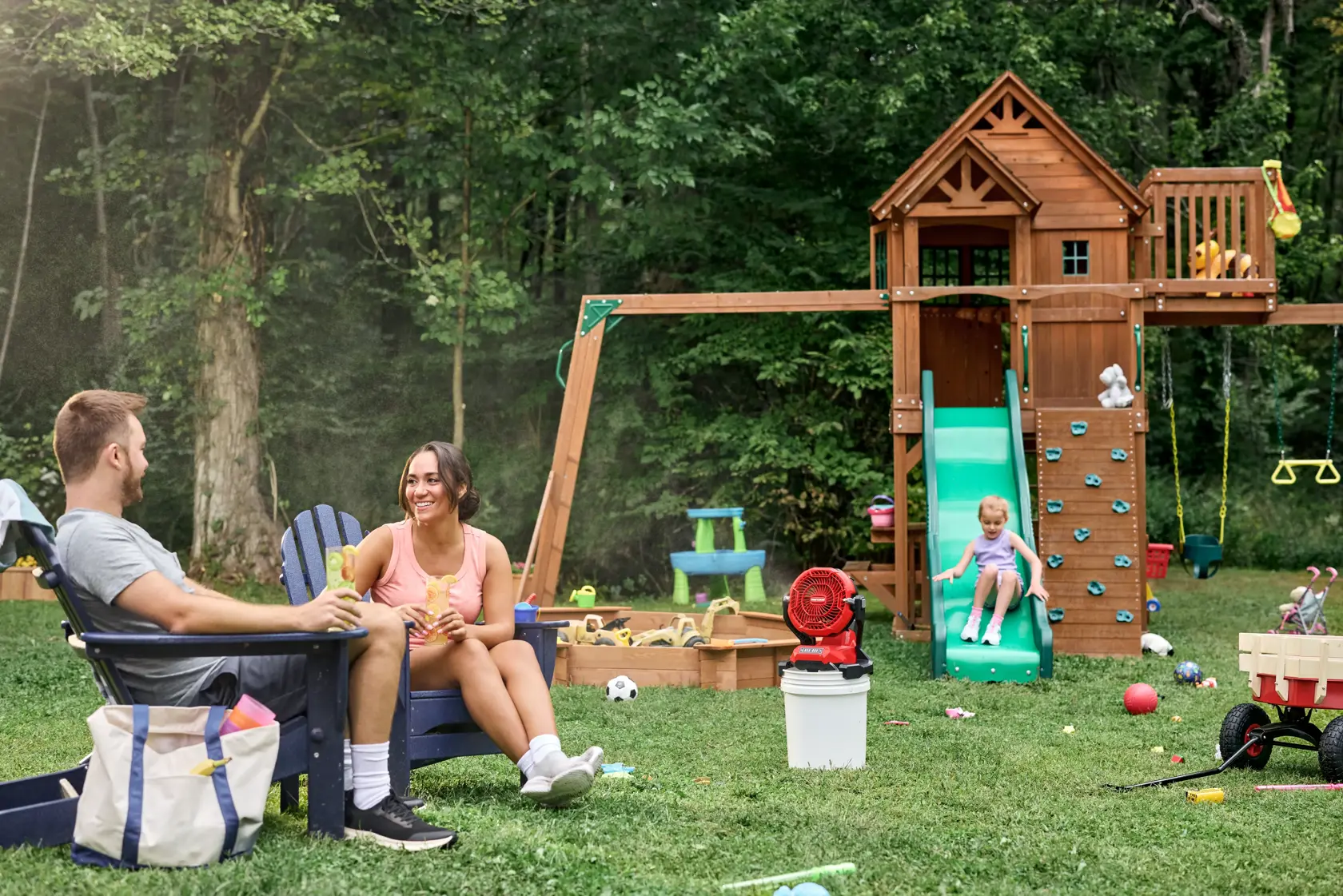 Family enjoying the CRAFTSMAN� V20* Cordless Misting Fan with the 5 gallon bucket