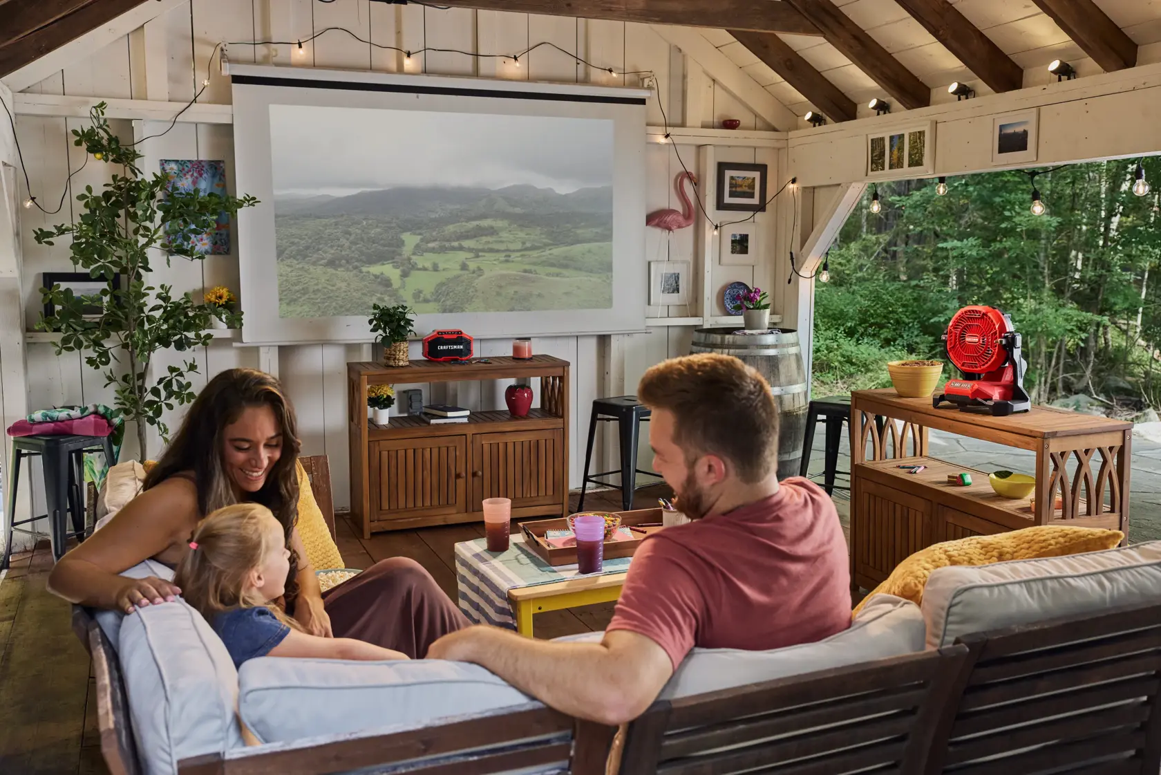 Family enjoying movie night with the CRAFTSMAN� V20* Cordless Misting Fan and Bluetooth Speaker