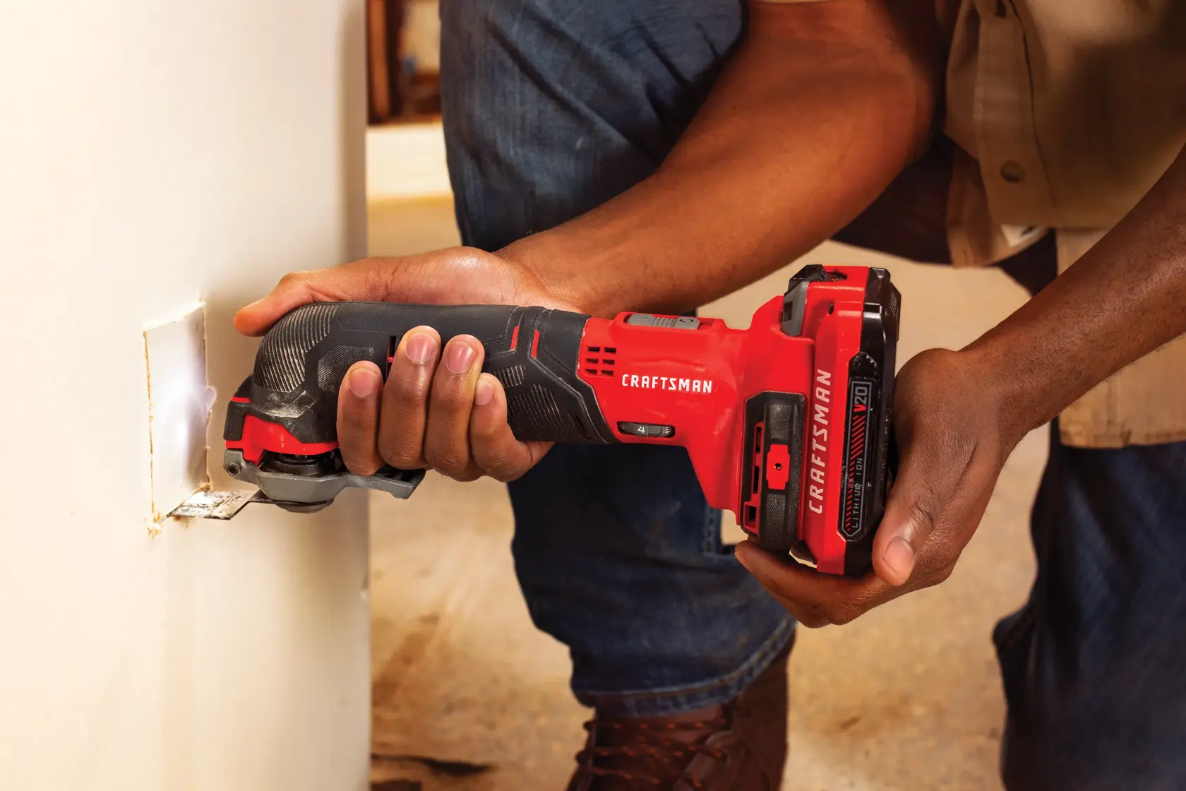 Photo of a person using Craftsman cordless oscillating multi-tool SKU CMCE501D1 to cut drywall.