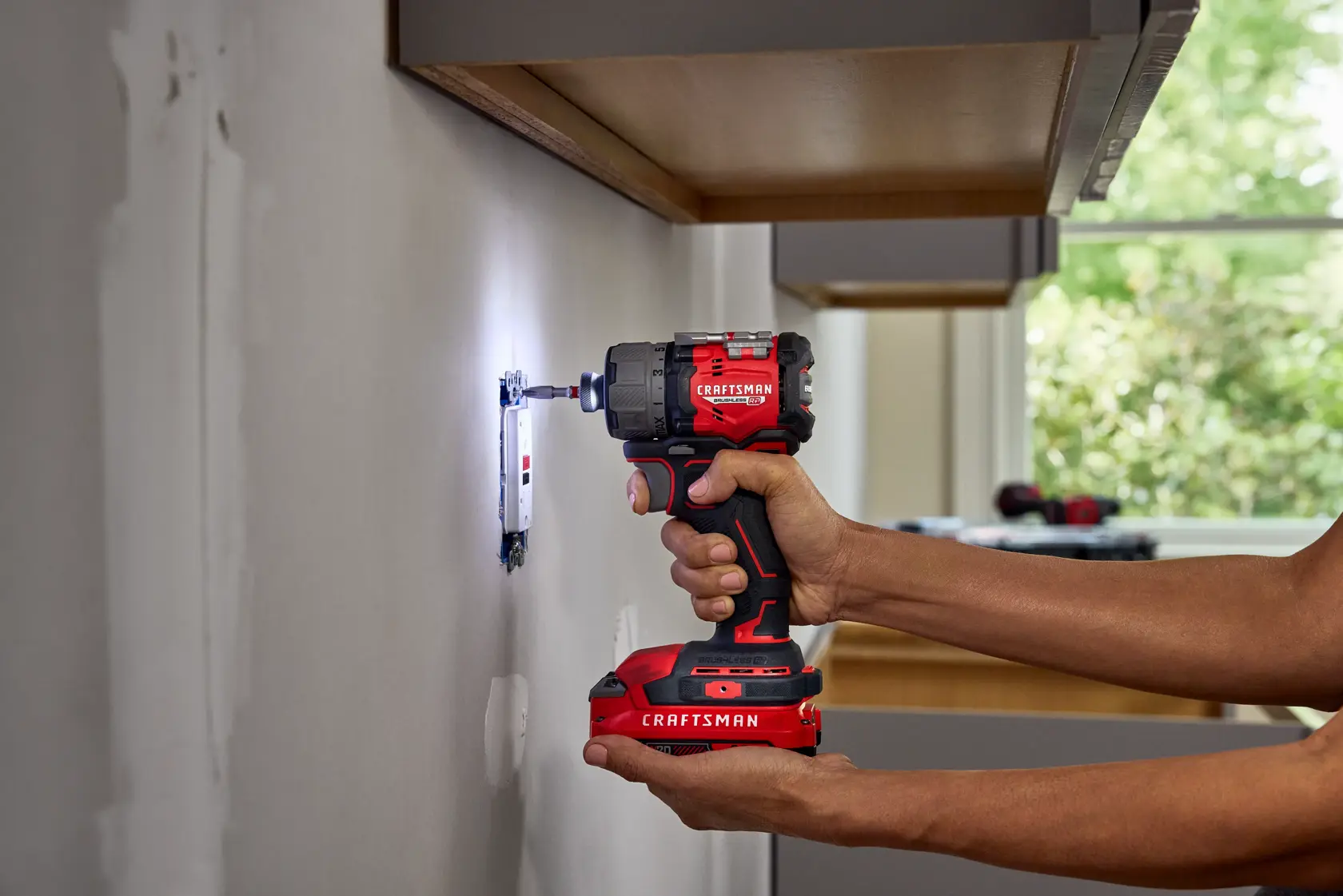 CRAFTSMAN V20* RP Screwdriver securing outlet in dark environment highlighting lights on tool