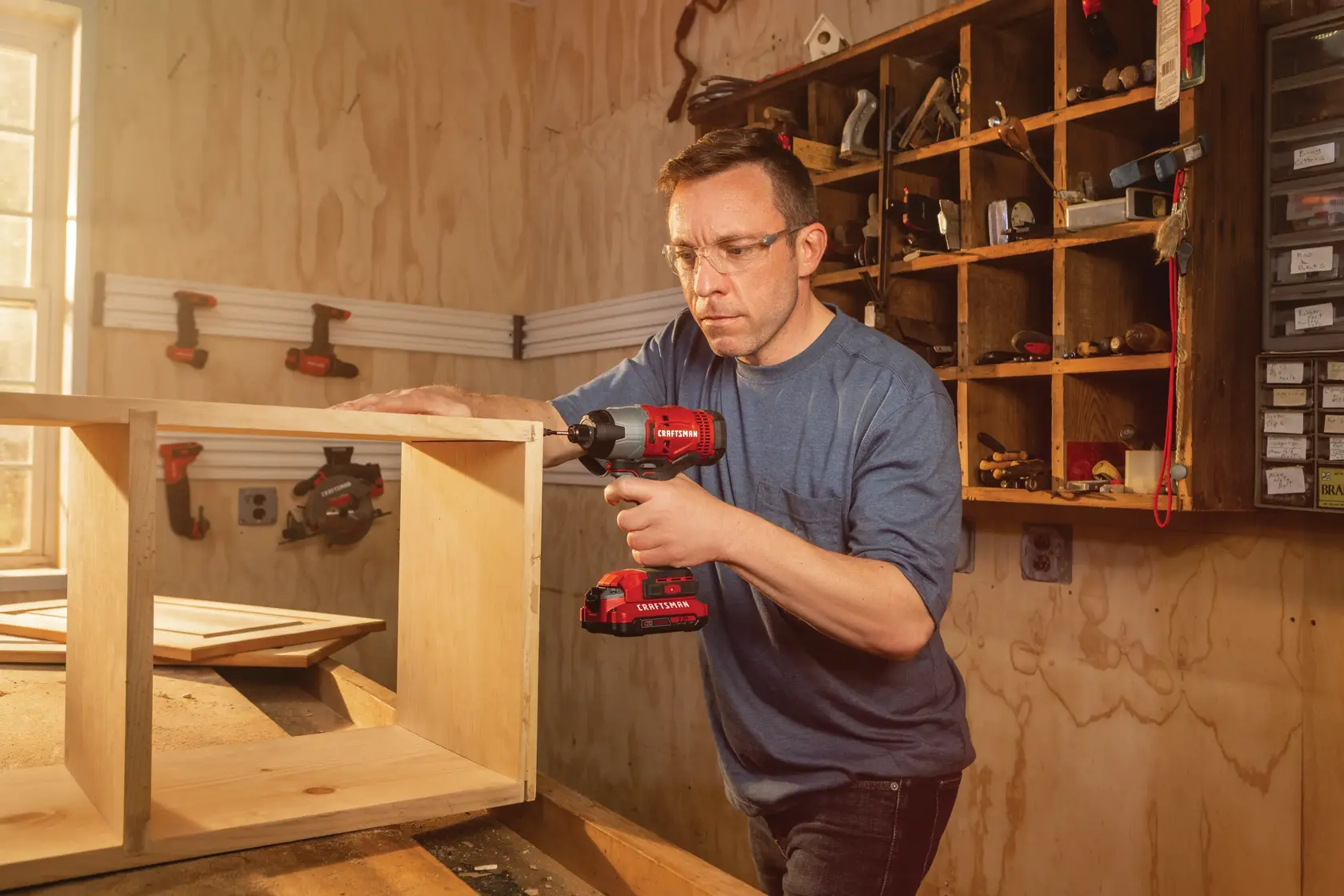20 volt  cordless quarter inch 2 batteries impact driver kit being used to drive in screws.