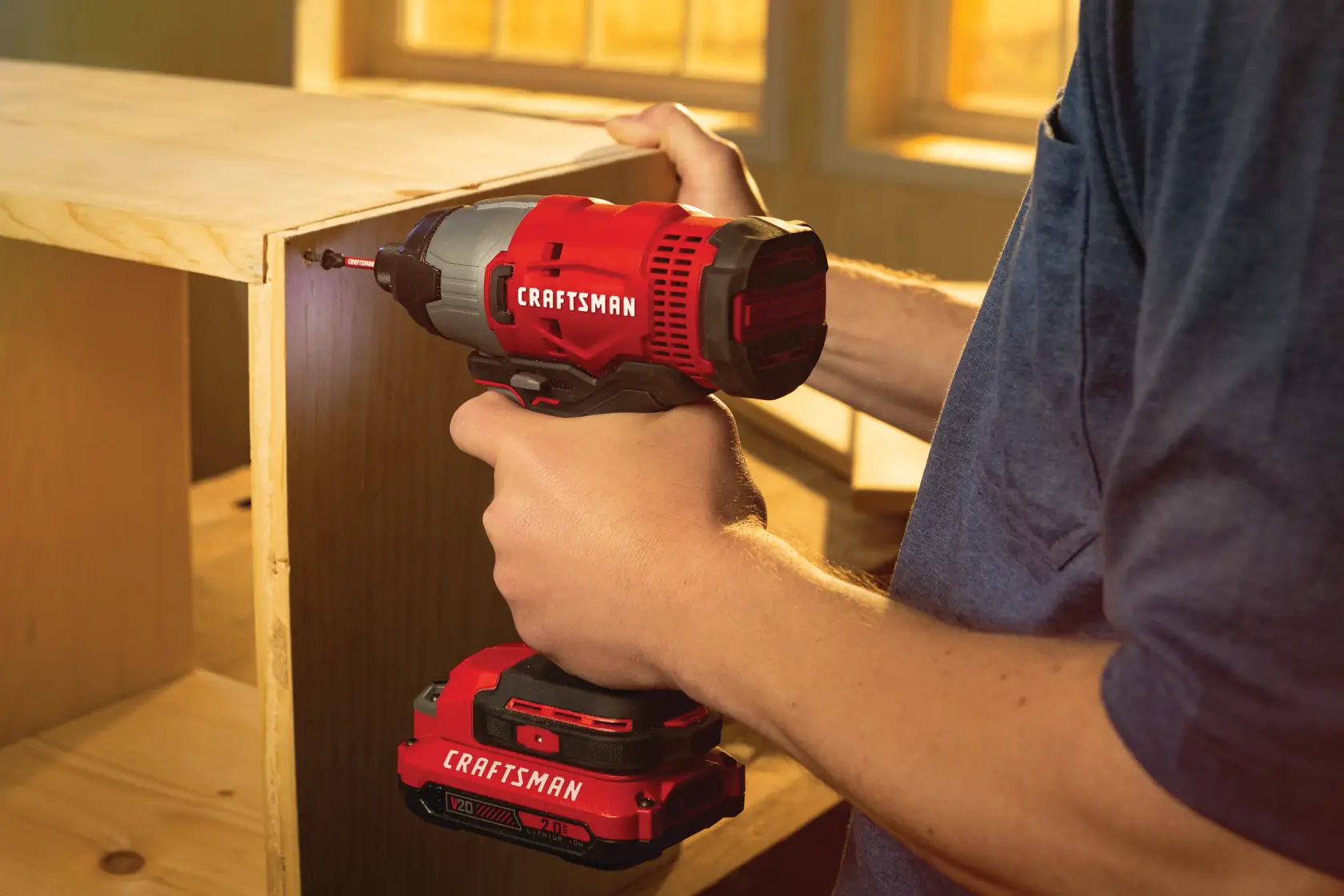 20 volt  cordless quarter inch impact driver kit 2 batteries being use to drive screws through.