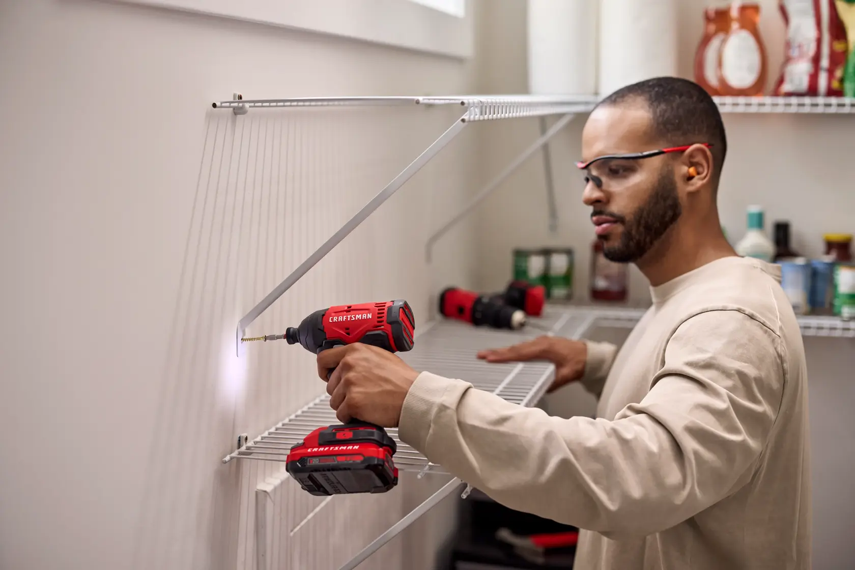 Man building kitchen pantry shelving with the CRAFTSMAN� V20* Brushed Impact Driver