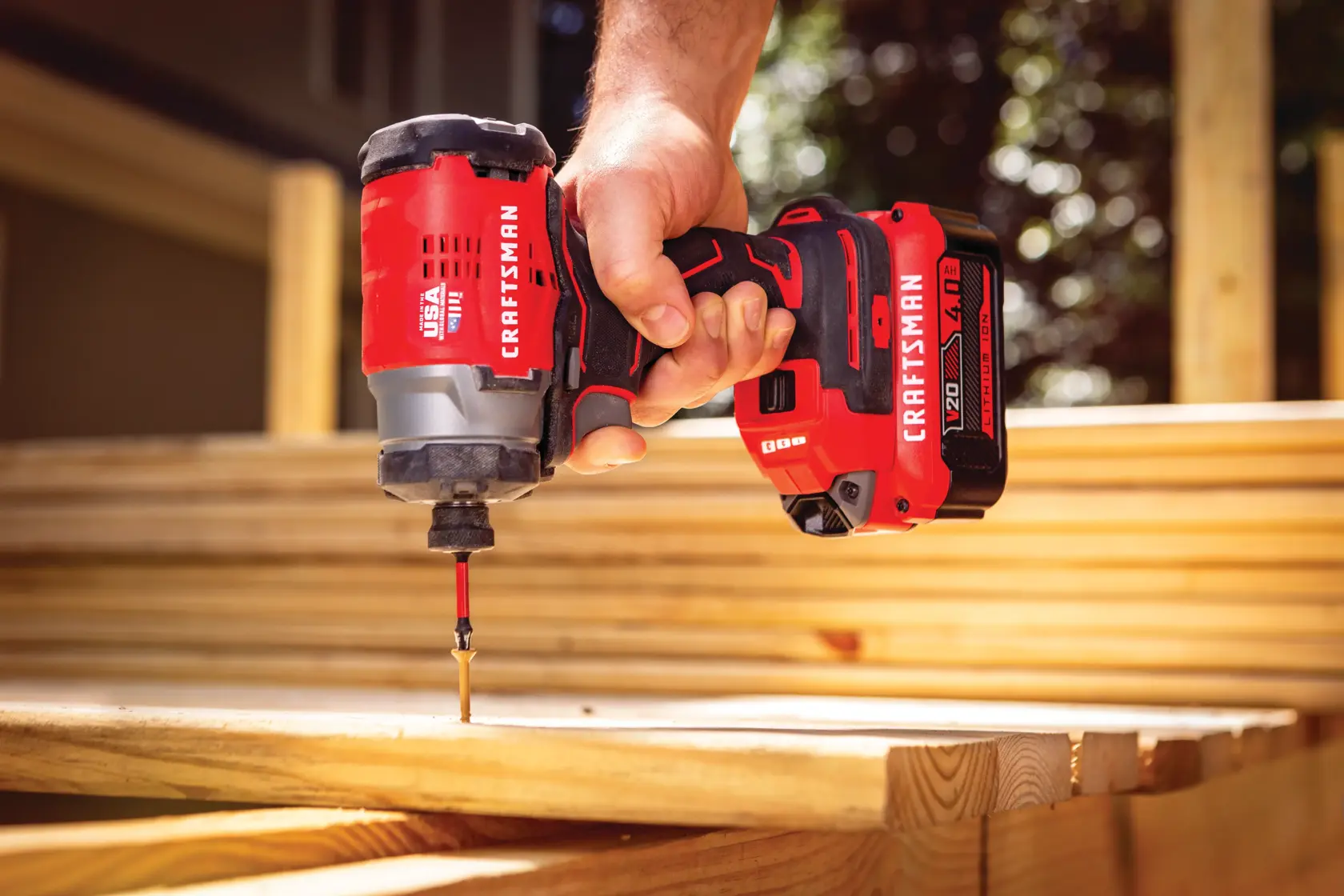 Brushless cordless impact driver 2 batteries being used to drill in screws.