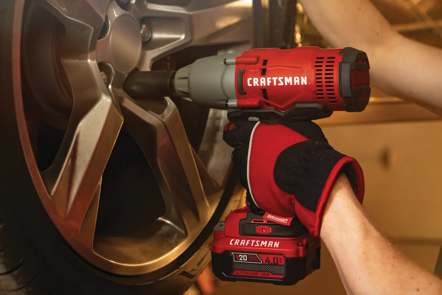 Cordless half inch impact wrench kit 1 battery being used to tighten tyre screws.