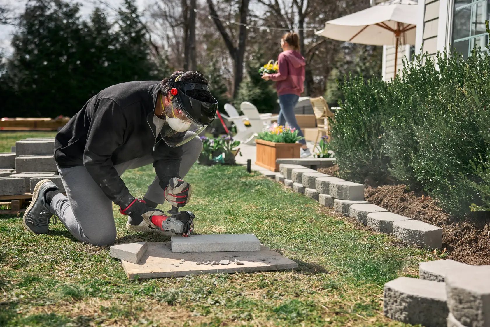 Man and woman working on patio cutting paver with CRAFTSMAN BRUSHLESS RP™ V20* Grinder