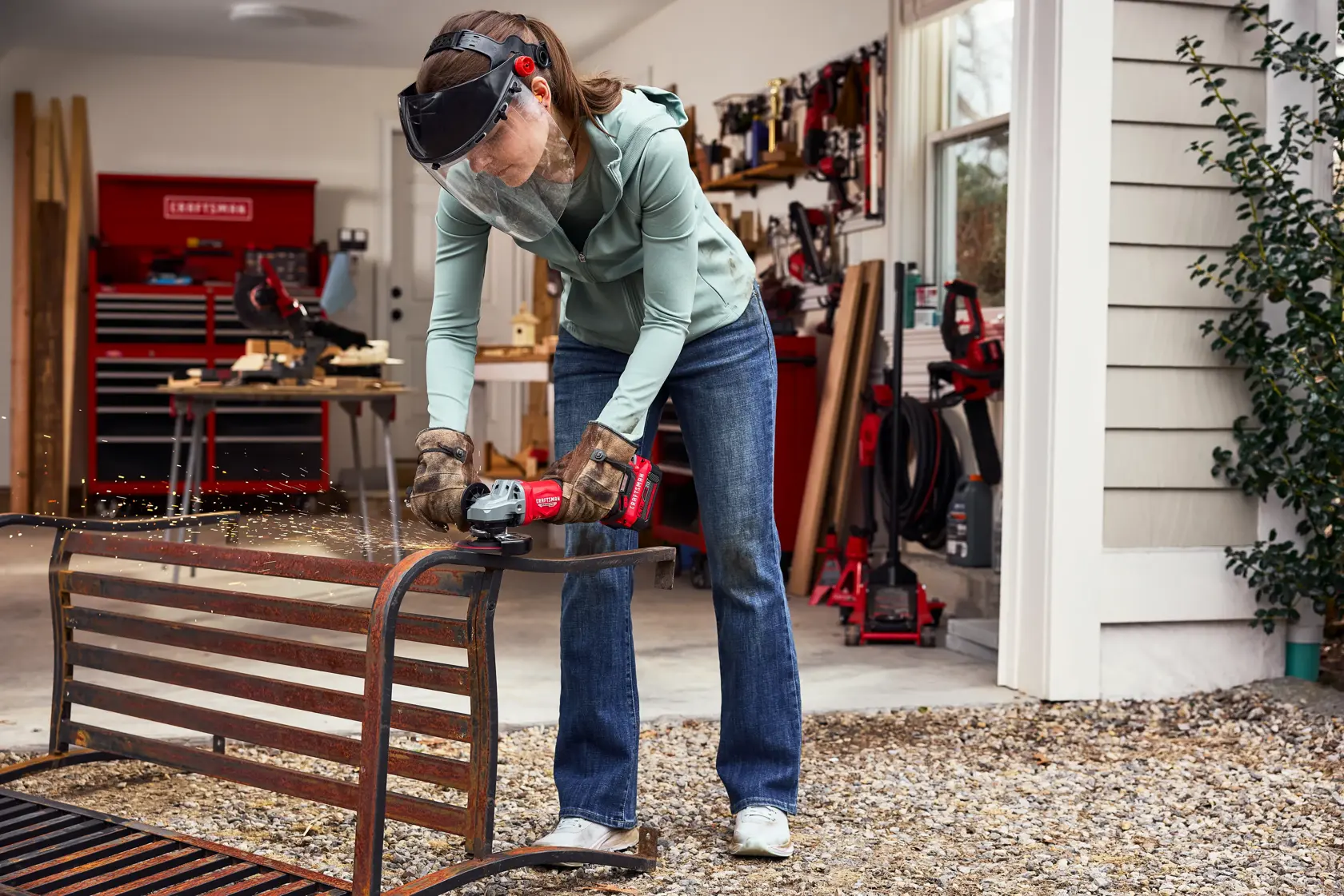 Woman grinding rusted old metal bench with CRAFTSMAN BRUSHLESS RP™ V20* Grinder