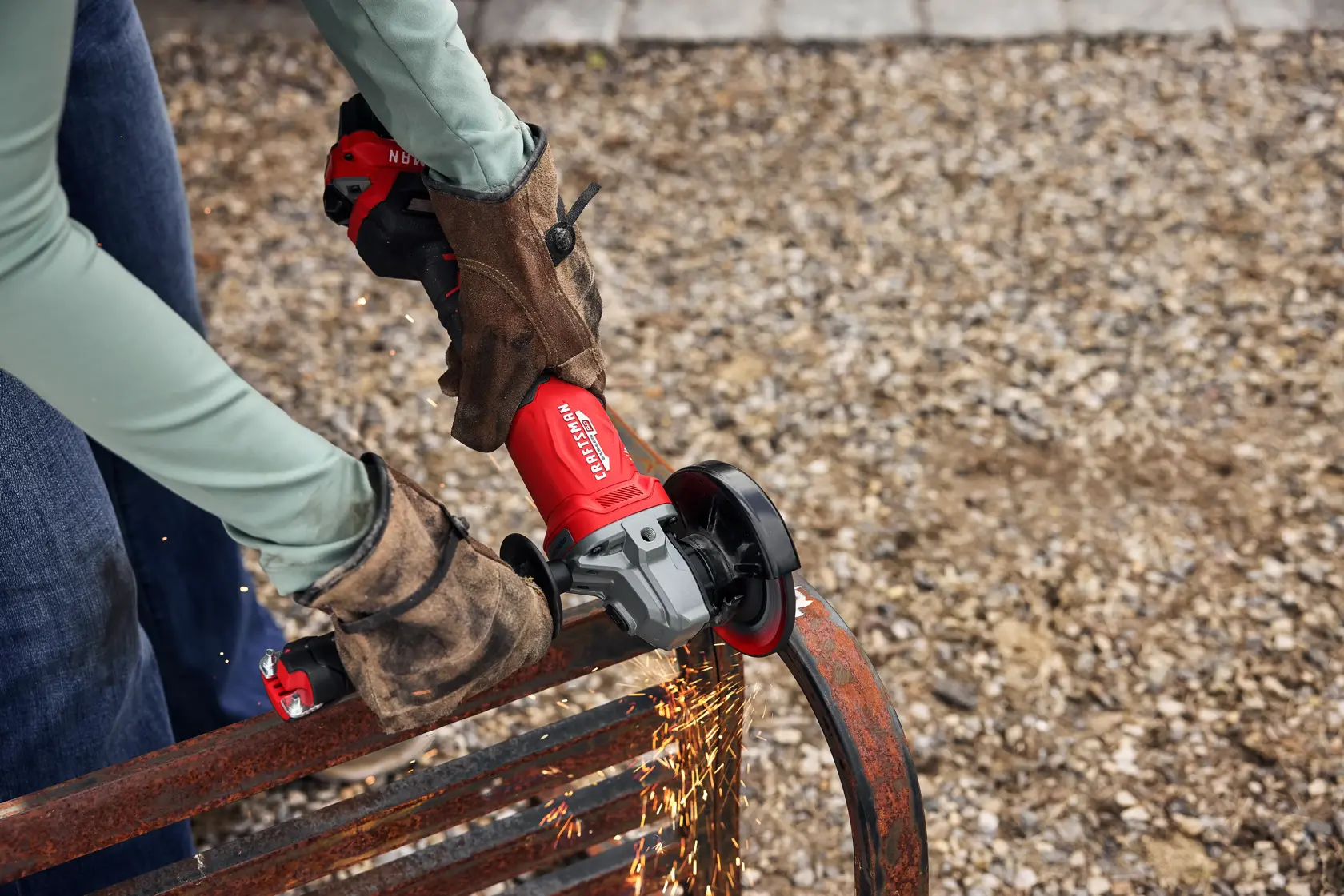 Close up of woman grinding rusted old metal bench with CRAFTSMAN BRUSHLESS RP™ V20* Grinder