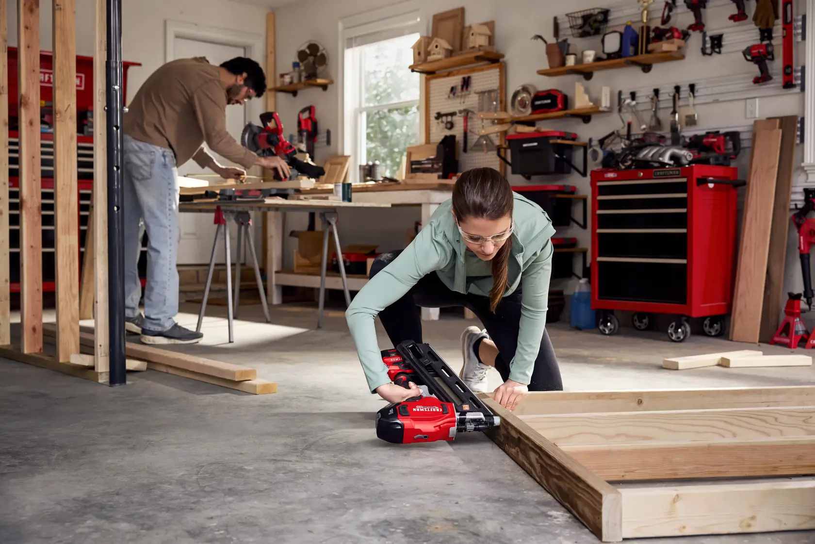 Photo of Craftsman CMCN630PTB nailer in use during woodworking with visible red tool chest and workshop tools.