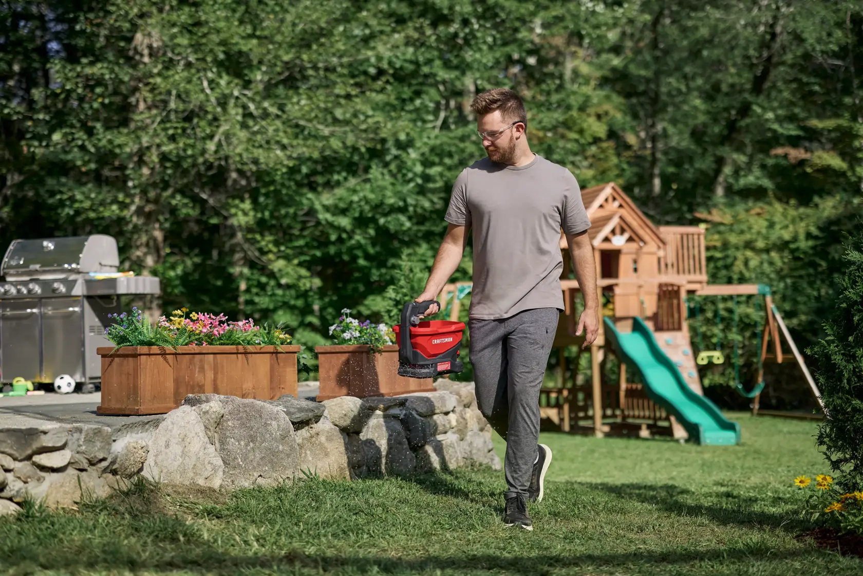 Man seeding grass with the CRAFTSMAN� V20* 4 Season Seeder Spreader Tool Only