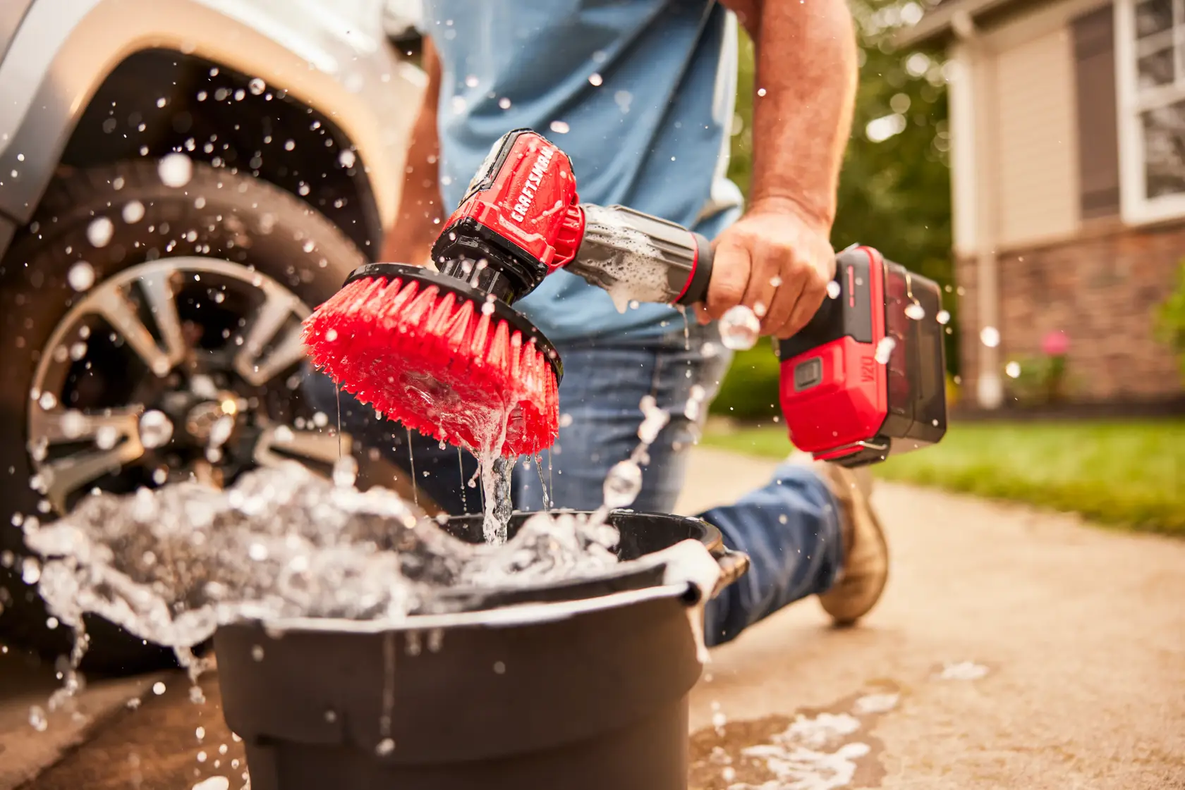 Zoom in view of male pulling out V20 Scrubber out of a bucket of water