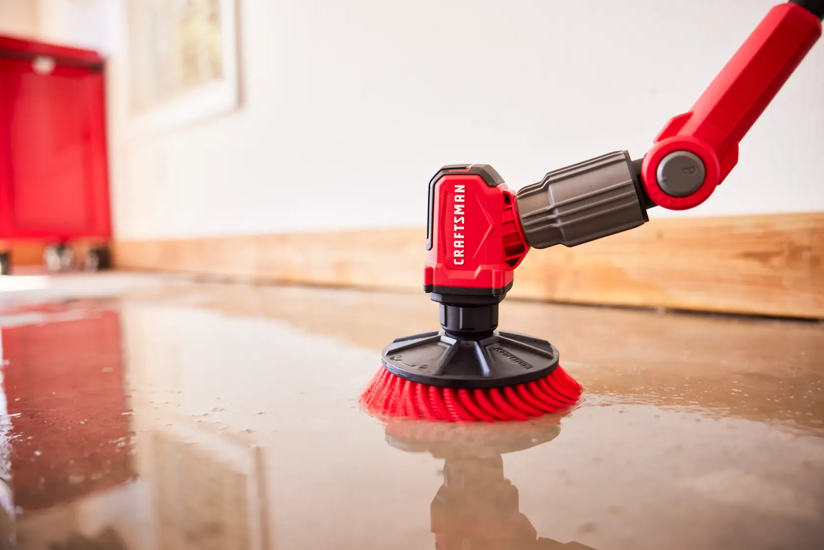 Zoom in of person cleaning garage floor with V20 Scubber 